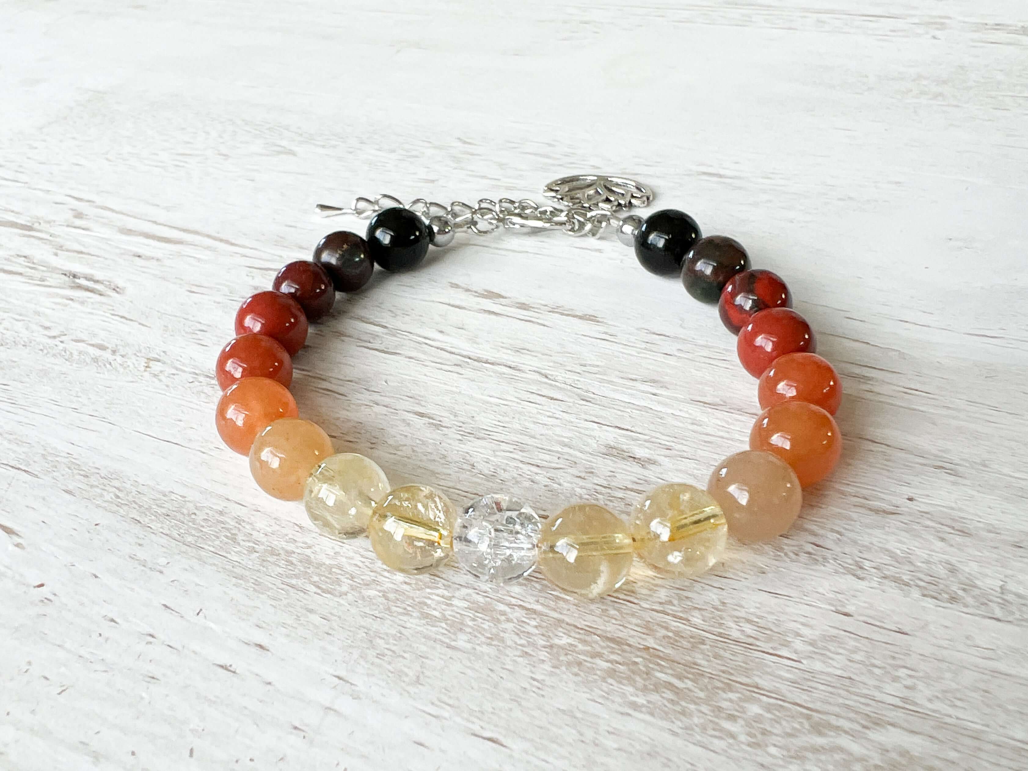 Fire Element Bracelet This bracelet is made with Black Obsidian, Red Jasper, Red Aventurine, Citrine, and Clear Quartz to represent the fire element. These stones bring the wearer a sense of self empowerment, determination, and clarity.