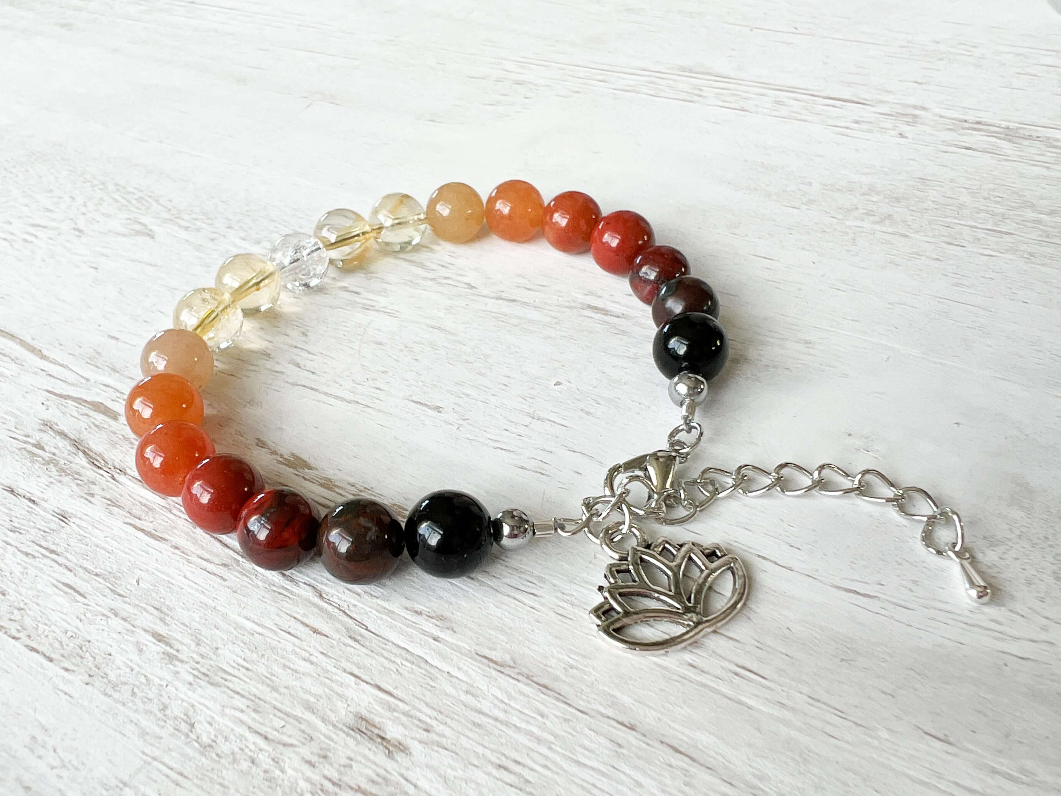 Fire Element Bracelet This bracelet is made with Black Obsidian, Red Jasper, Red Aventurine, Citrine, and Clear Quartz to represent the fire element. These stones bring the wearer a sense of self empowerment, determination, and clarity.