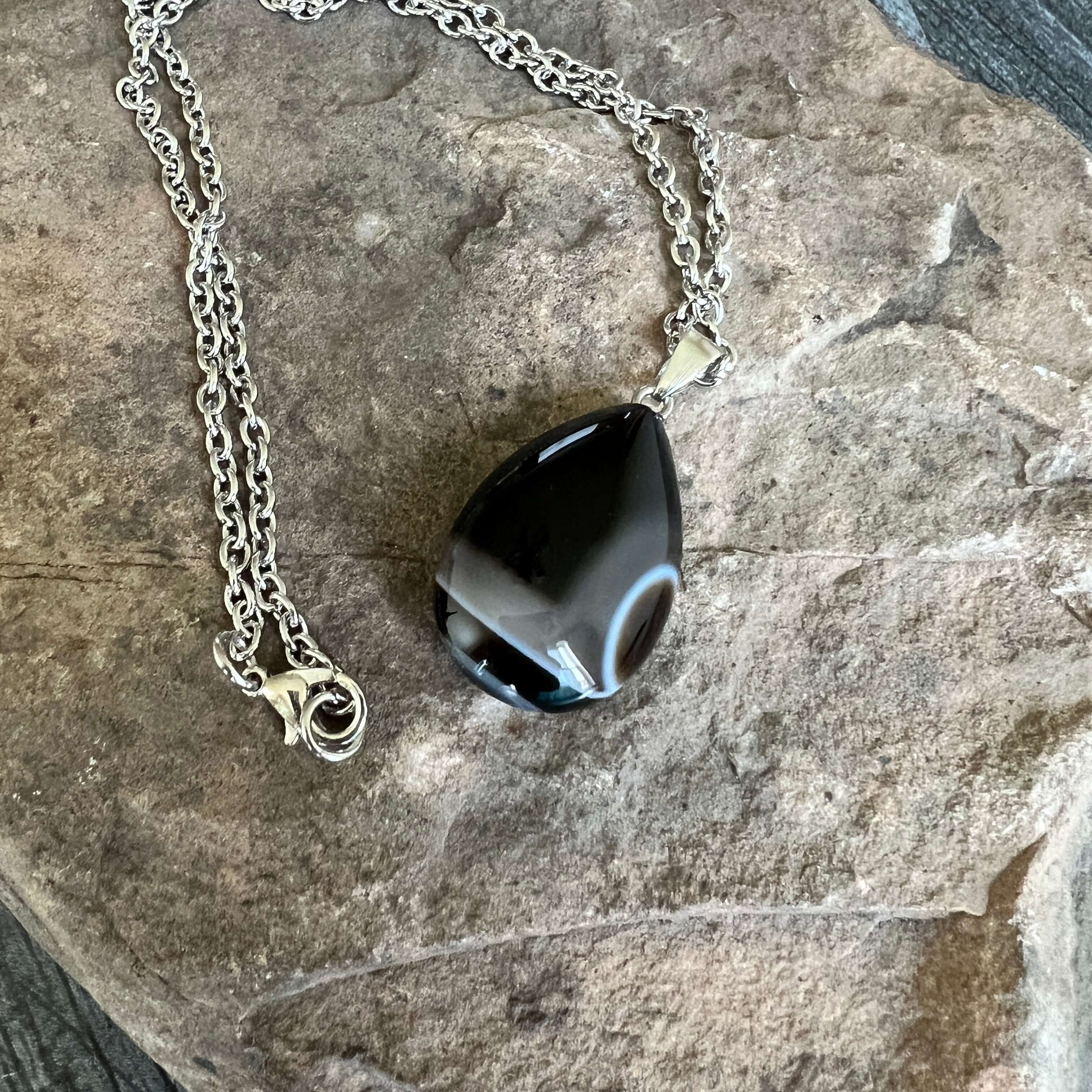 Tuxedo Agate Teardrop Necklace This necklace is made with a high-quality Tuxedo Agate stone which brings stability and release to the wearer. Zodiac: Gemini & Virgo Chakras: Third Eye, Root, Crown & Heart. Handmade with authentic crystals and gemstones.