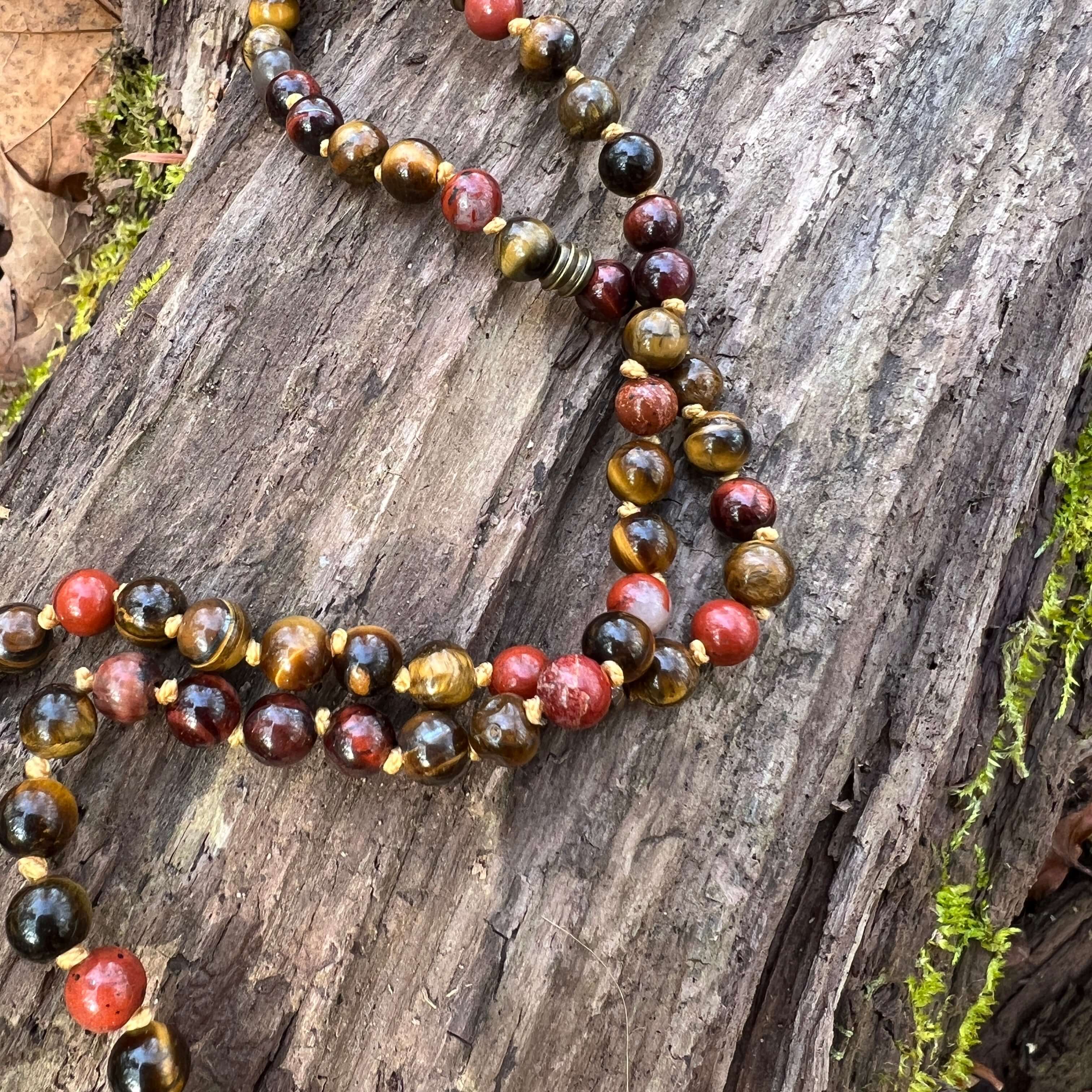 Tiger Eye Mala This mala is made with brown Tiger Eye, Red Tiger Eye, and Mookaite stones which bring a stable, grounding energy to the wearer. Due to the uniqueness of natural stone, your mala may look slightly different than the one pictured. Making you