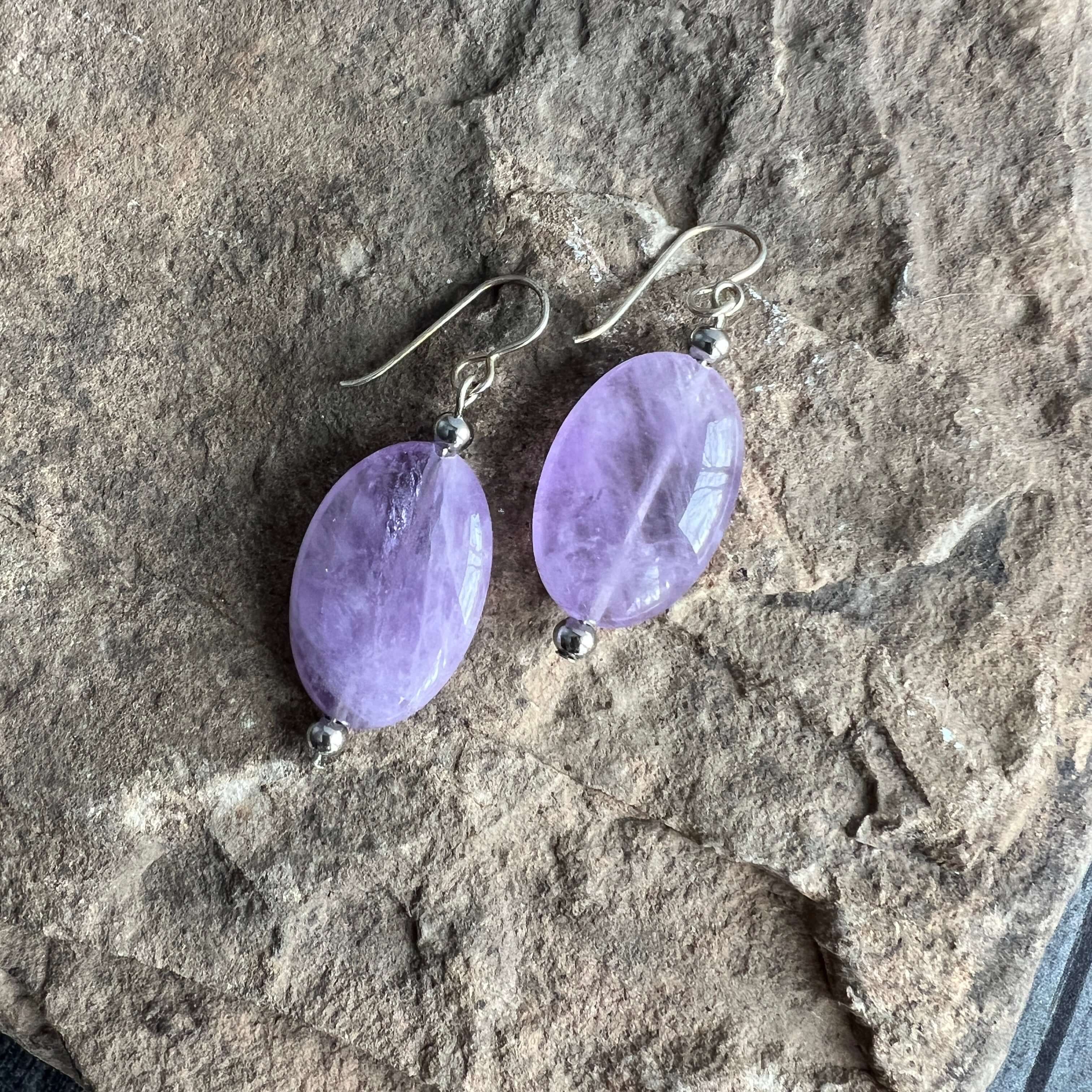 Lavender Amethyst Earrings These earrings are made with high-quality Amethyst stones which bring serenity to the wearer. Amethyst is a stone of serenity. This stone helps to calm the mind. It was once known as a “Gem of Fire” by ancient cultures. It has b