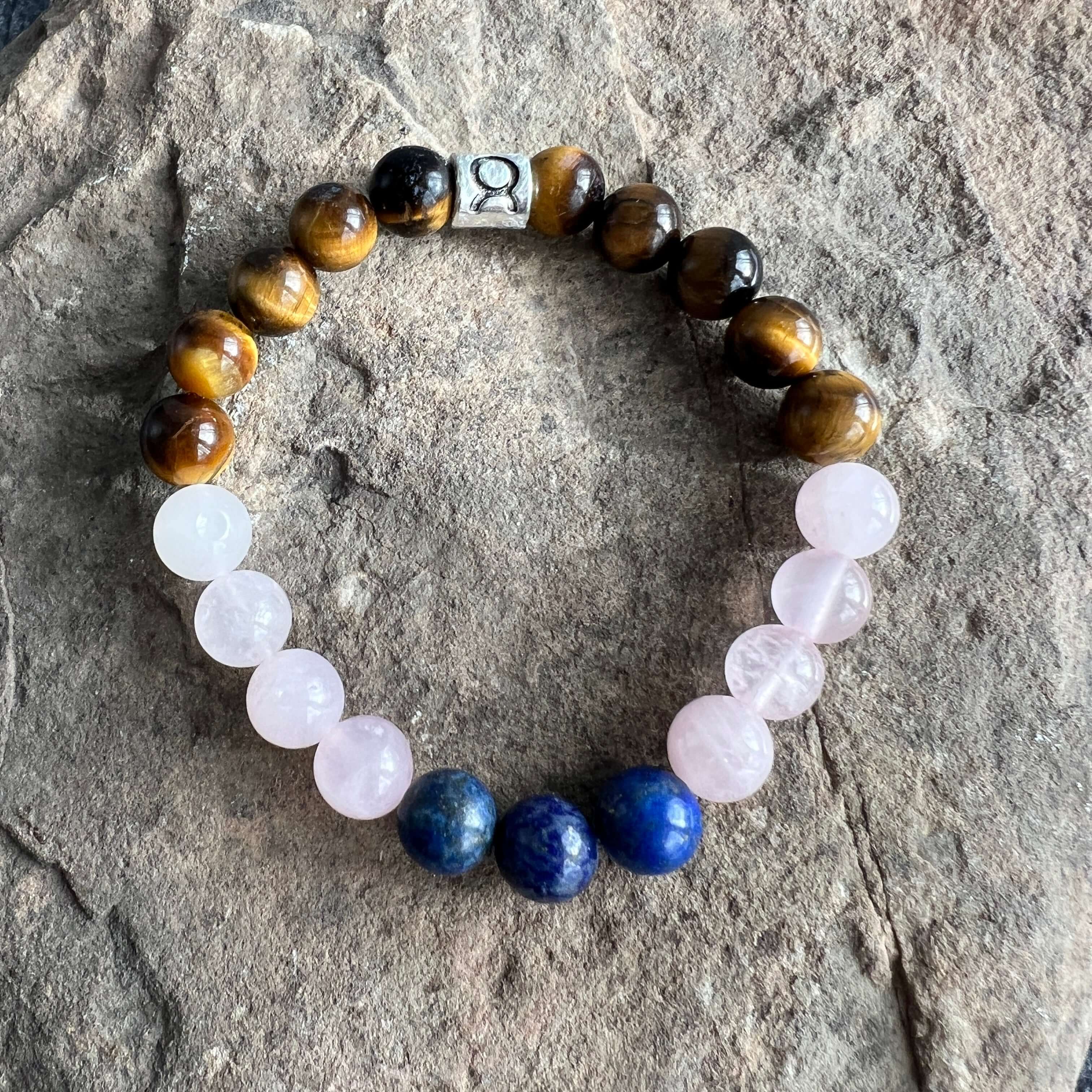 Taurus Zodiac Bracelet The Taurus Zodiac Bracelet is created with a combination of Rose Quartz, Lapis Lazuli, and Tiger Eye beads which resonate with the grounded and sensual qualities associated with this zodiac sign.