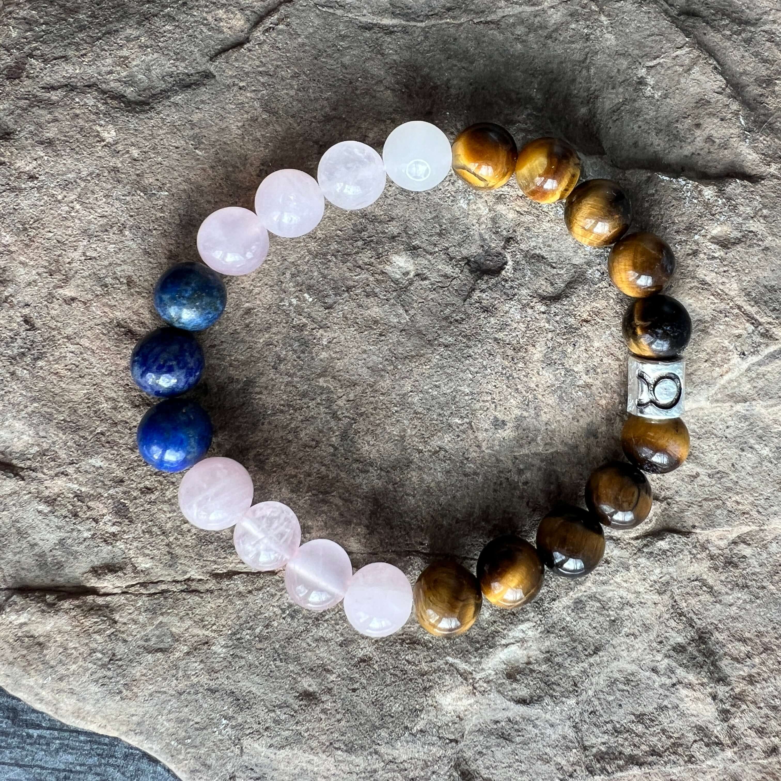 Taurus Zodiac Bracelet The Taurus Zodiac Bracelet is created with a combination of Rose Quartz, Lapis Lazuli, and Tiger Eye beads which resonate with the grounded and sensual qualities associated with this zodiac sign.