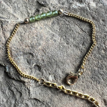 Load image into Gallery viewer, August birthstone bracelet made with 4mm faceted Peridot gemstones on gold plated chain.
