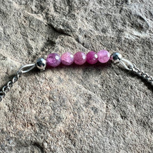 Load image into Gallery viewer, Close up of July birthstone bracelet made with 4mm faceted Ruby gemstones on stainless steel chain.
