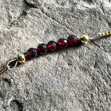 Load image into Gallery viewer, Close up of January birthstone bracelet with faceted Garnet stones.
