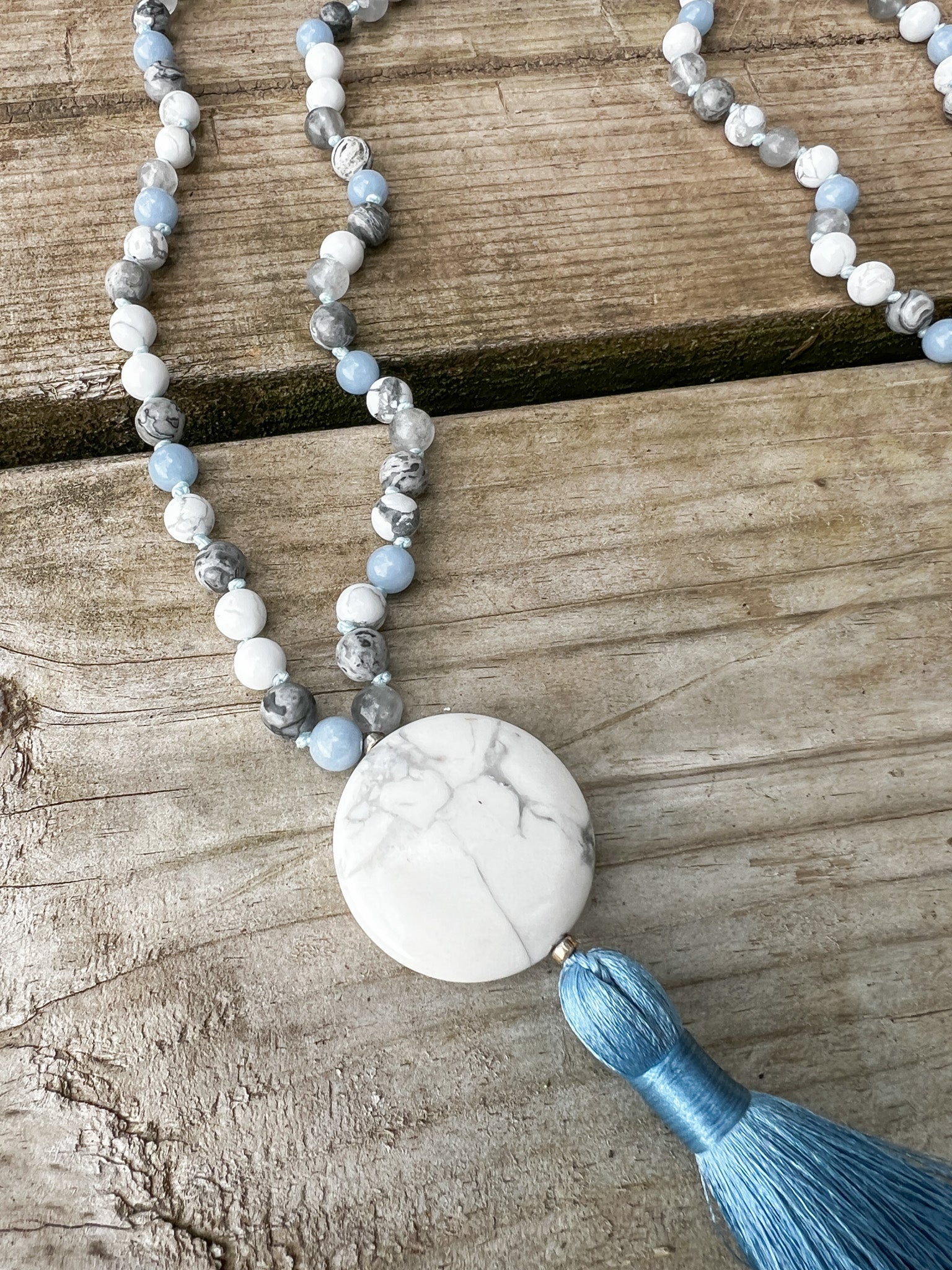Detailed view of the Open Sky Mala Necklace highlighting the natural veining in the Howlite focal stone and hand-knotted gemstone beads.