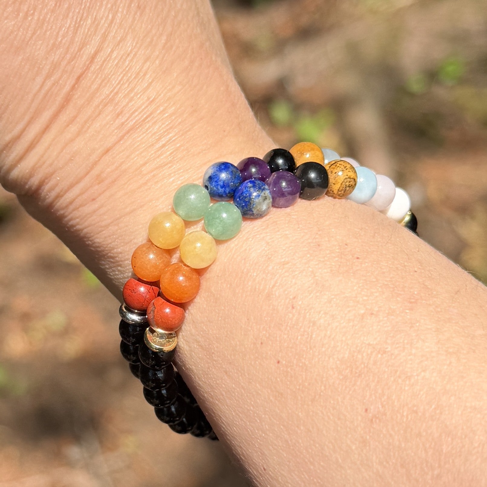 Multicolored beaded bracelet on a wrist with a blurred natural background