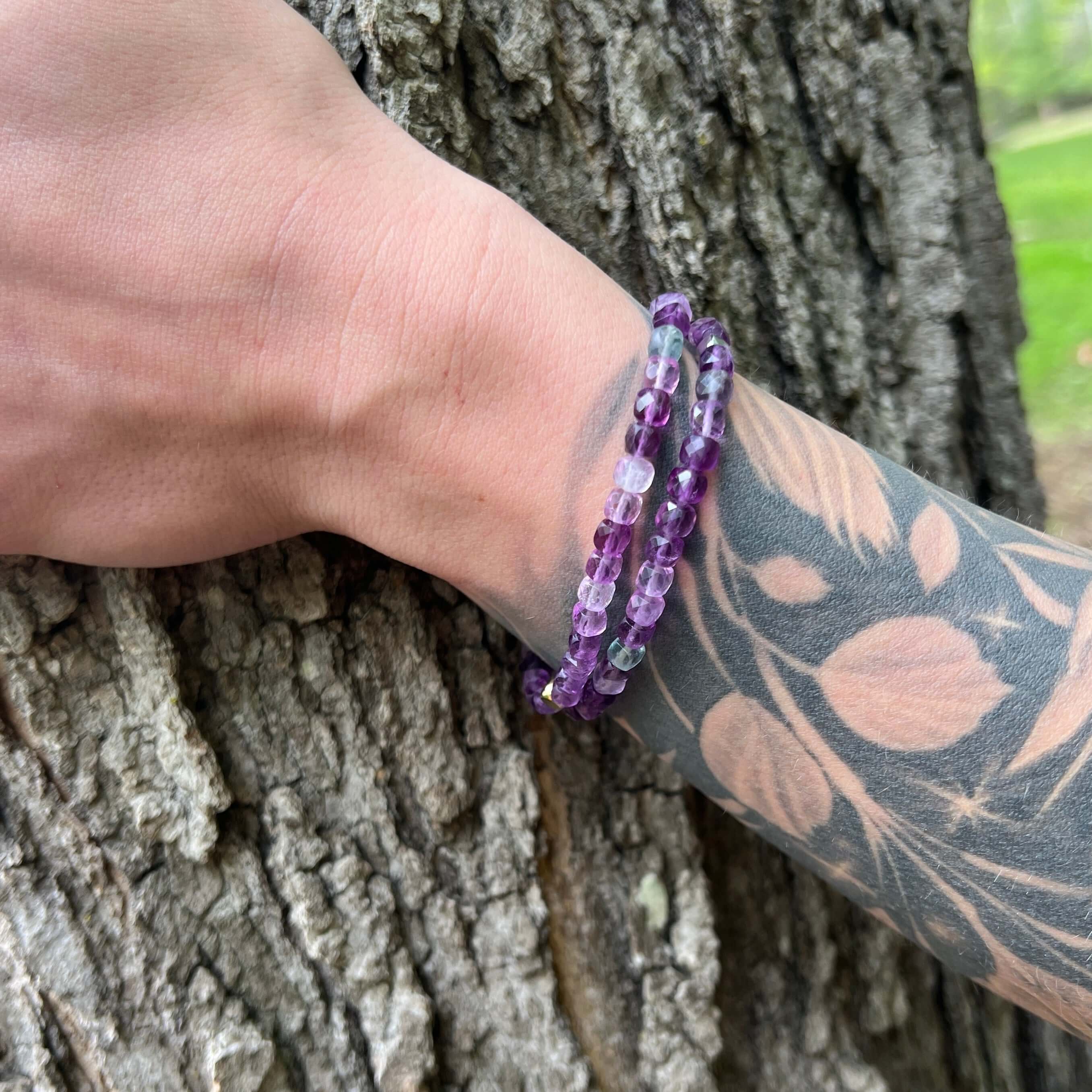 Purple Fluorite Cube Bead Bracelets on model with tree bark background.