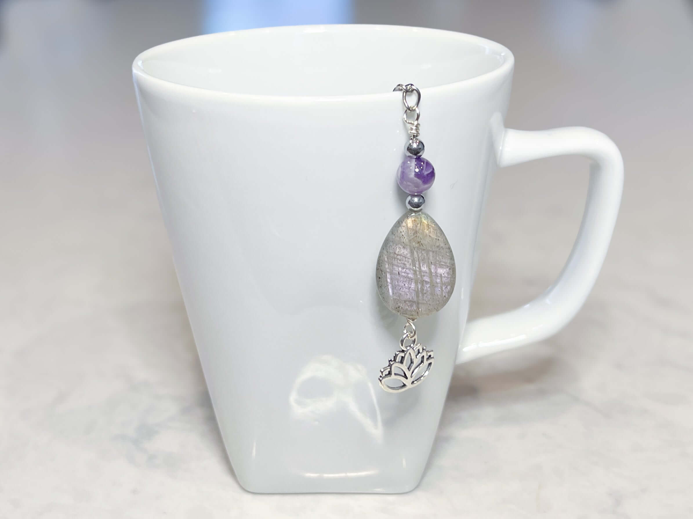 Amethyst and Labradorite Tea Strainer This tea strainer is made with a stainless steel tea ball, Chevron Amethyst, Labradorite, and Hematite beads. These stones offer clarity, transformation, and protection to the user.