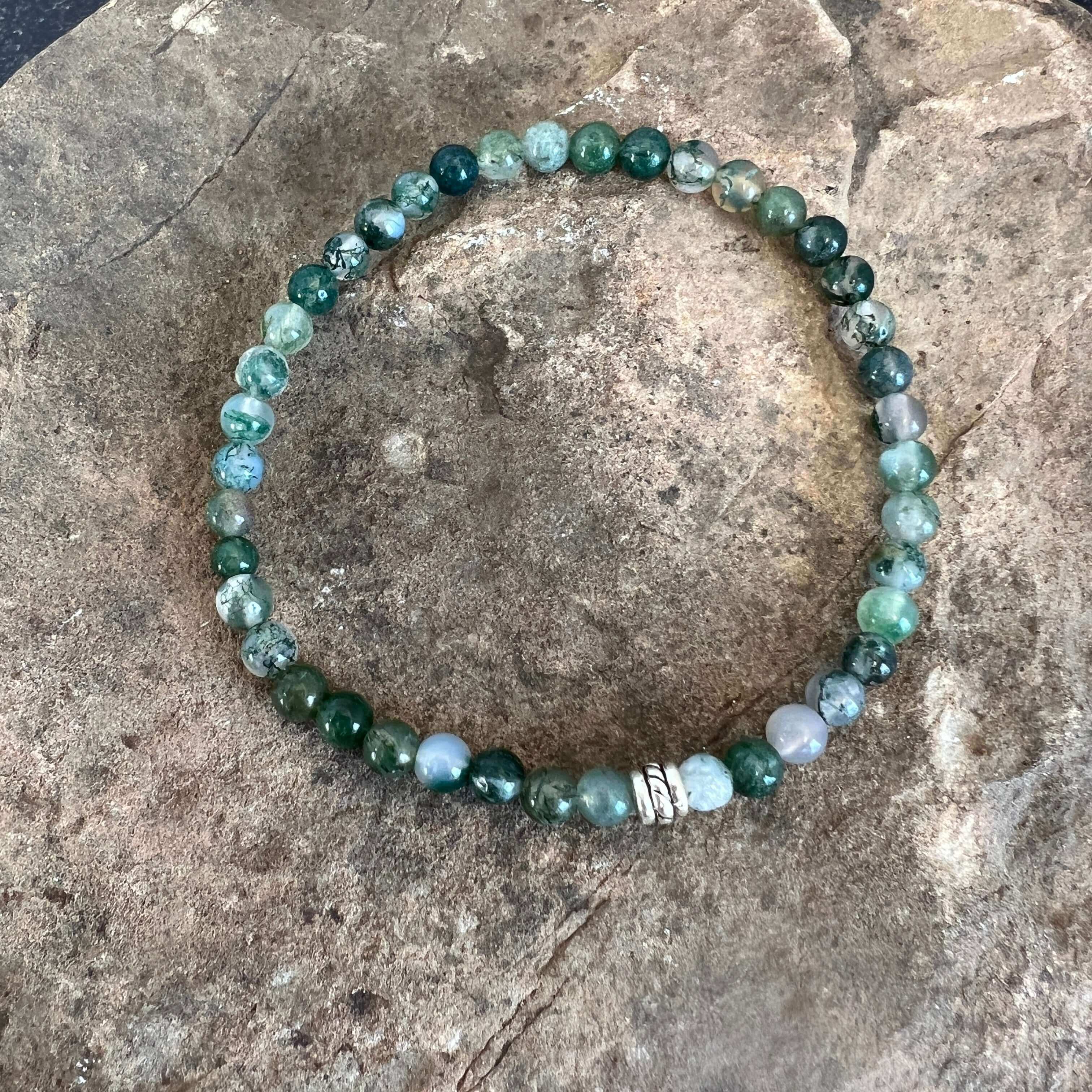 Moss Agate Bracelet This bracelet is made with high-quality Moss Agate gemstones which bring abundance and grounding energy to the wearer. Zodiac Sign: Virgo. Chakra: Heart. Handmade with authentic crystals & gemstones in Minneapolis, MN.