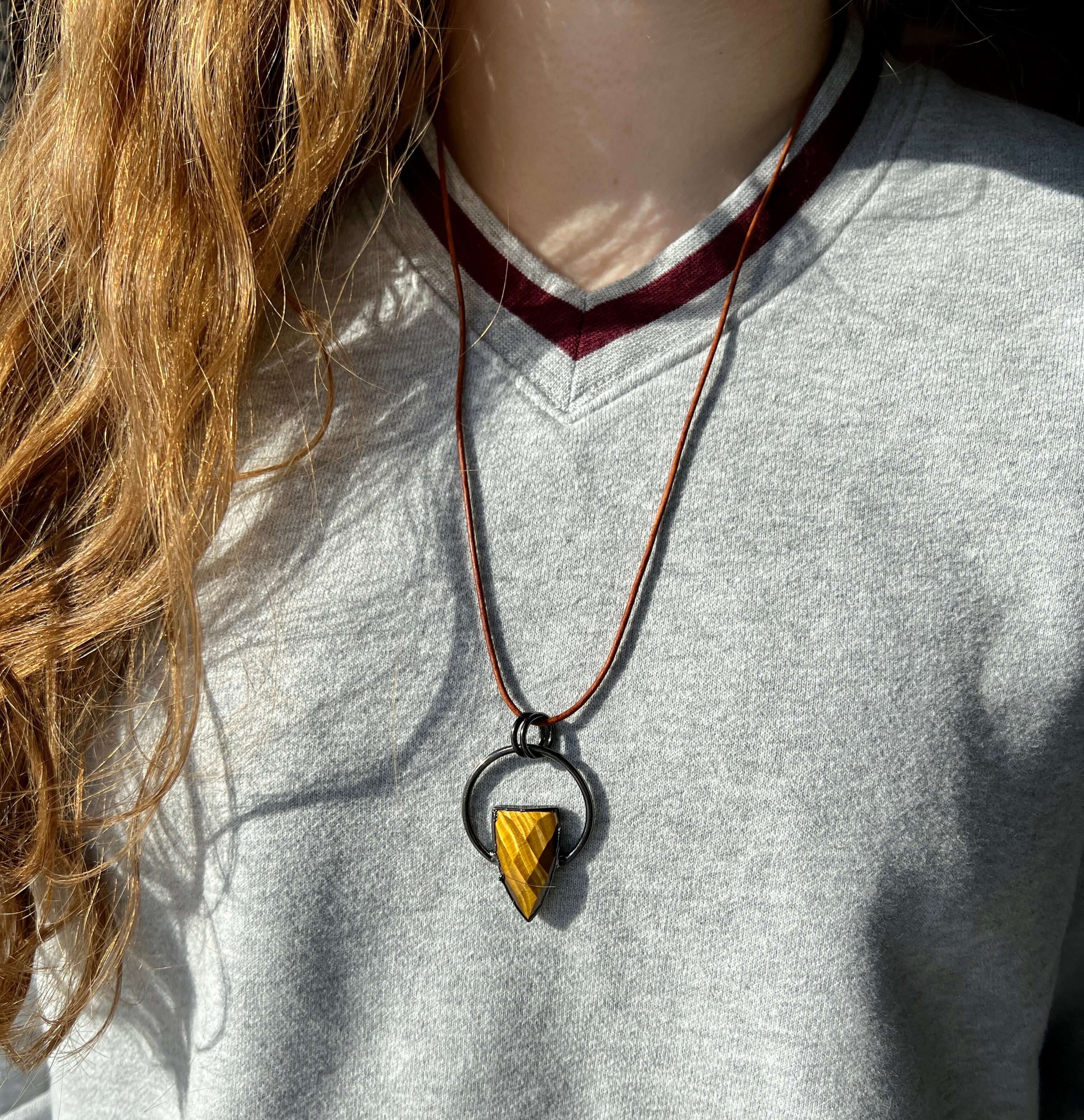Tiger Eye Pendant Slide Knot Necklace This necklace is made with high-quality Tiger Eye gemstones which bring clarity and grounding energy to the wearer. Zodiac Signs: Leo and Capricorn. Chakras: Sacral, Solar Plexus, and Third Eye. Handmade with authenti
