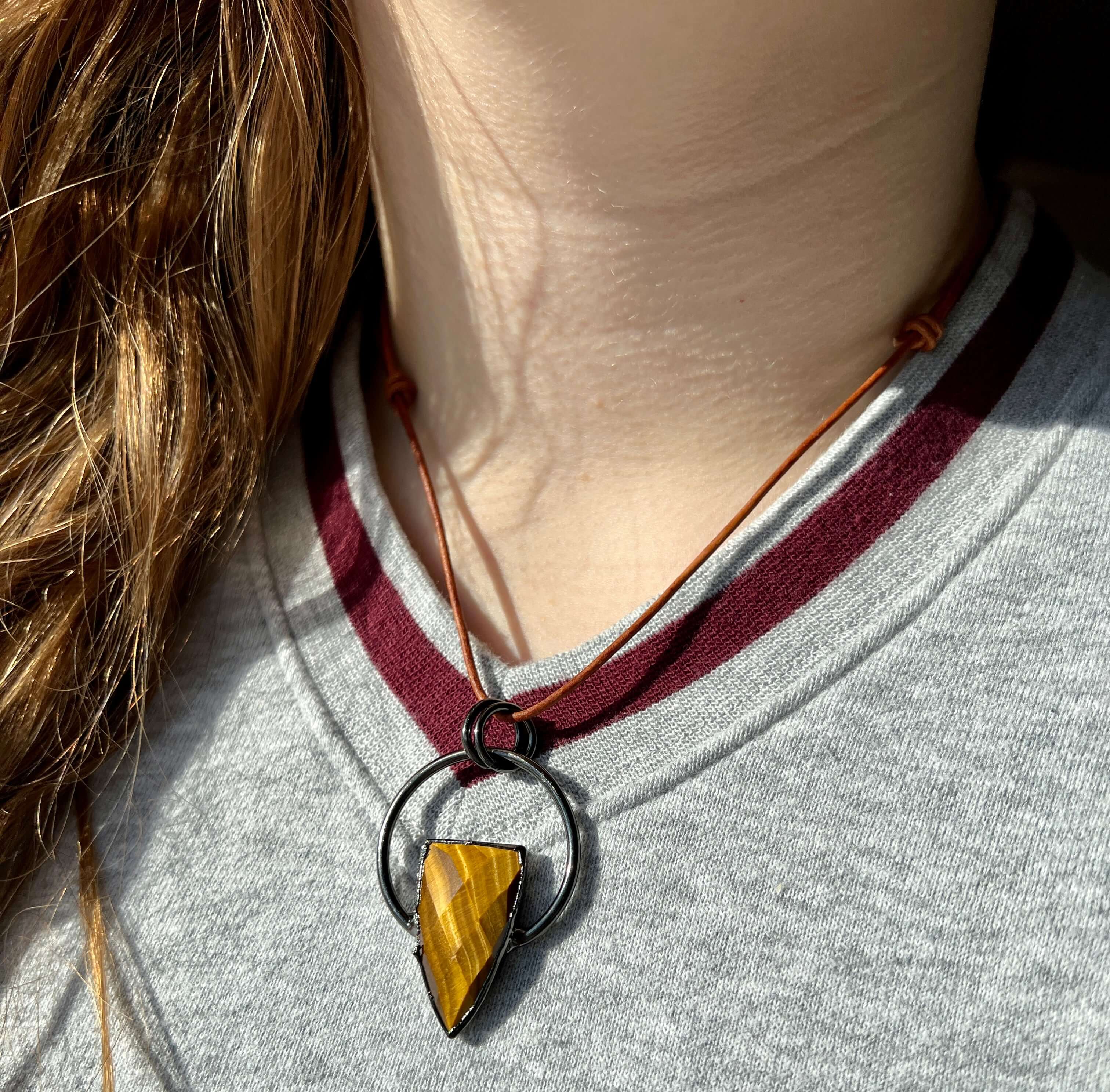 Tiger Eye Pendant Slide Knot Necklace This necklace is made with high-quality Tiger Eye gemstones which bring clarity and grounding energy to the wearer. Zodiac Signs: Leo and Capricorn. Chakras: Sacral, Solar Plexus, and Third Eye. Handmade with authenti