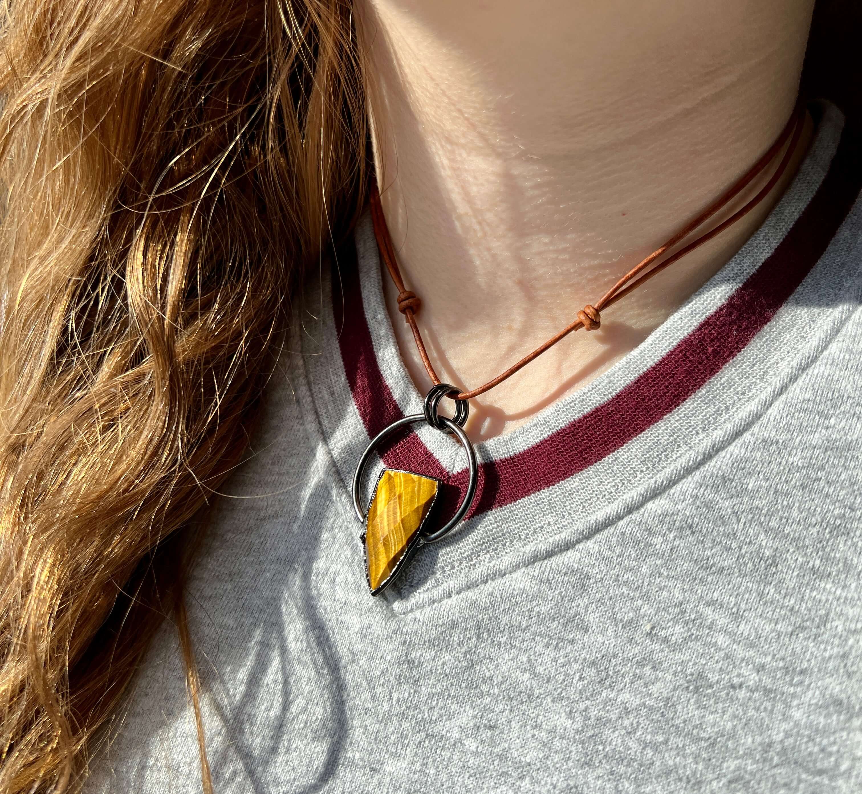 Tiger Eye Pendant Slide Knot Necklace This necklace is made with high-quality Tiger Eye gemstones which bring clarity and grounding energy to the wearer. Zodiac Signs: Leo and Capricorn. Chakras: Sacral, Solar Plexus, and Third Eye. Handmade with authenti