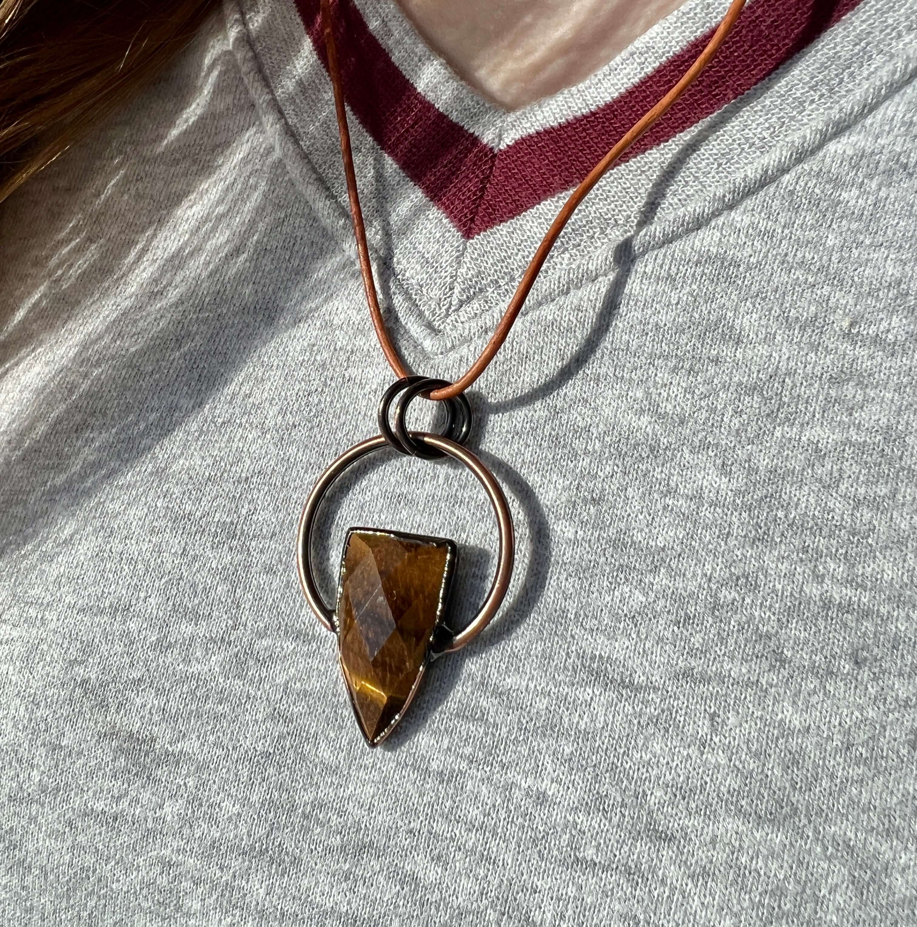 Tiger Eye Pendant Slide Knot Necklace This necklace is made with high-quality Tiger Eye gemstones which bring clarity and grounding energy to the wearer. Zodiac Signs: Leo and Capricorn. Chakras: Sacral, Solar Plexus, and Third Eye. Handmade with authenti