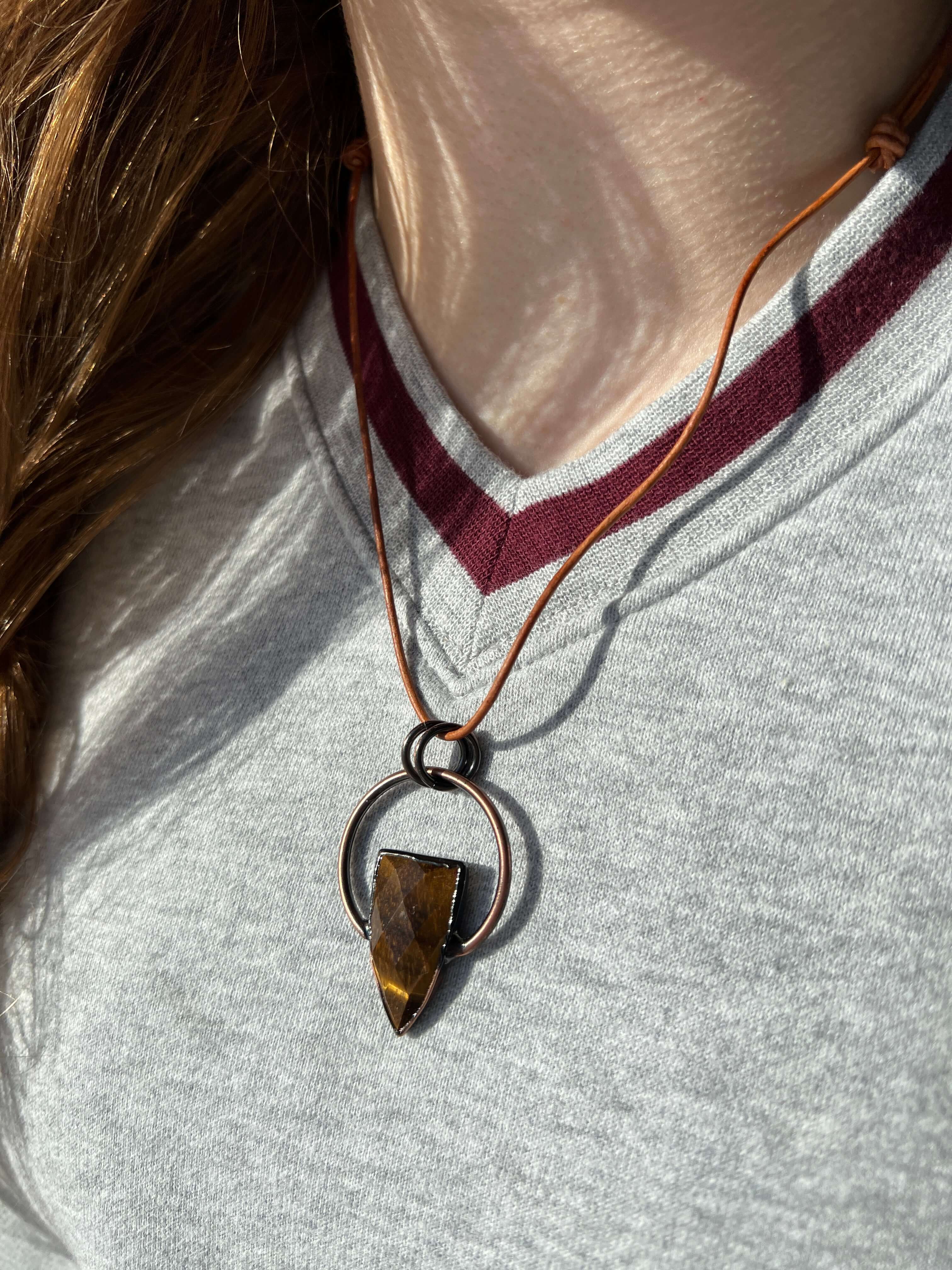 Tiger Eye Pendant Slide Knot Necklace This necklace is made with high-quality Tiger Eye gemstones which bring clarity and grounding energy to the wearer. Zodiac Signs: Leo and Capricorn. Chakras: Sacral, Solar Plexus, and Third Eye. Handmade with authenti
