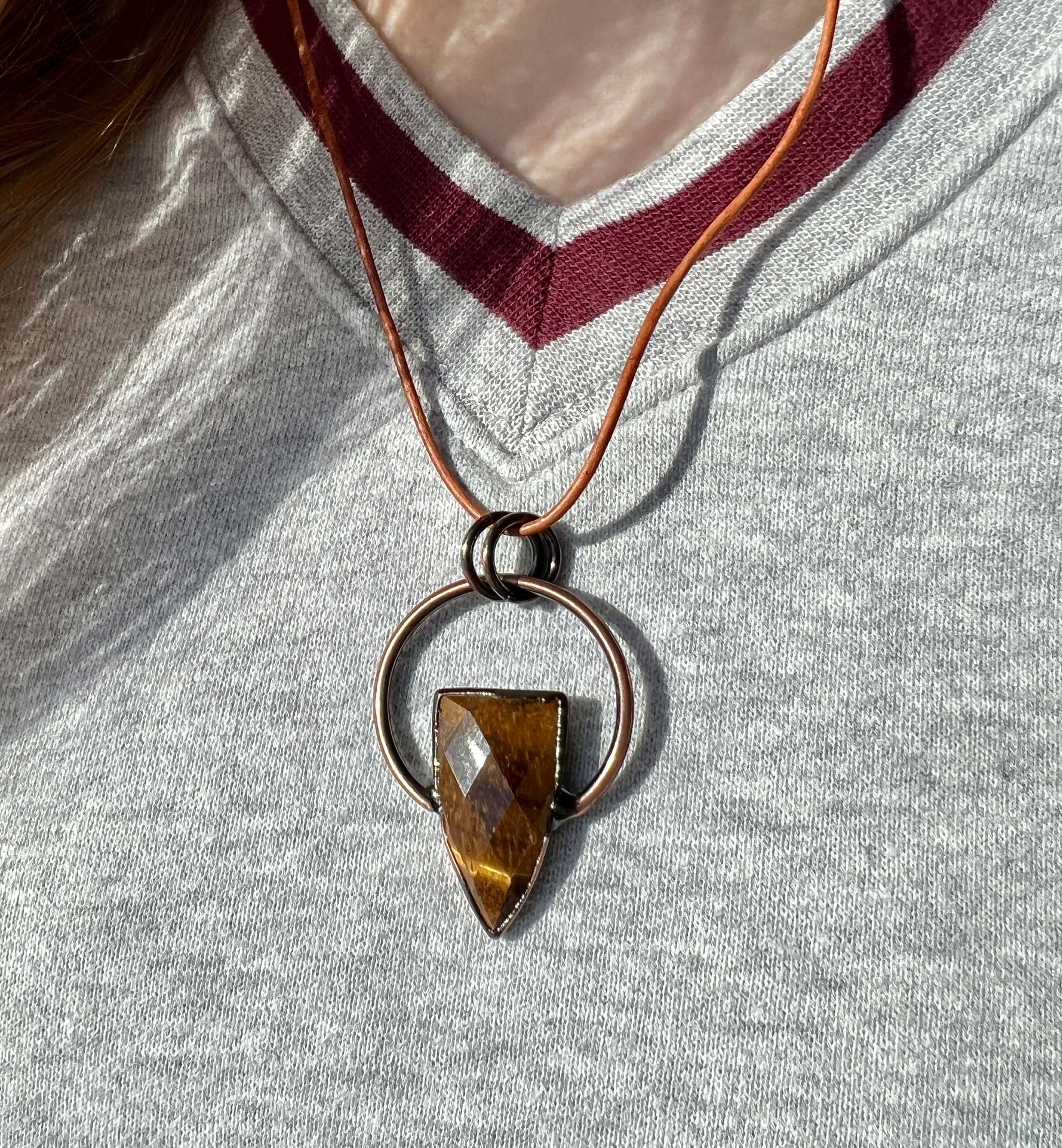 Tiger Eye Pendant Slide Knot Necklace This necklace is made with high-quality Tiger Eye gemstones which bring clarity and grounding energy to the wearer. Zodiac Signs: Leo and Capricorn. Chakras: Sacral, Solar Plexus, and Third Eye. Handmade with authenti