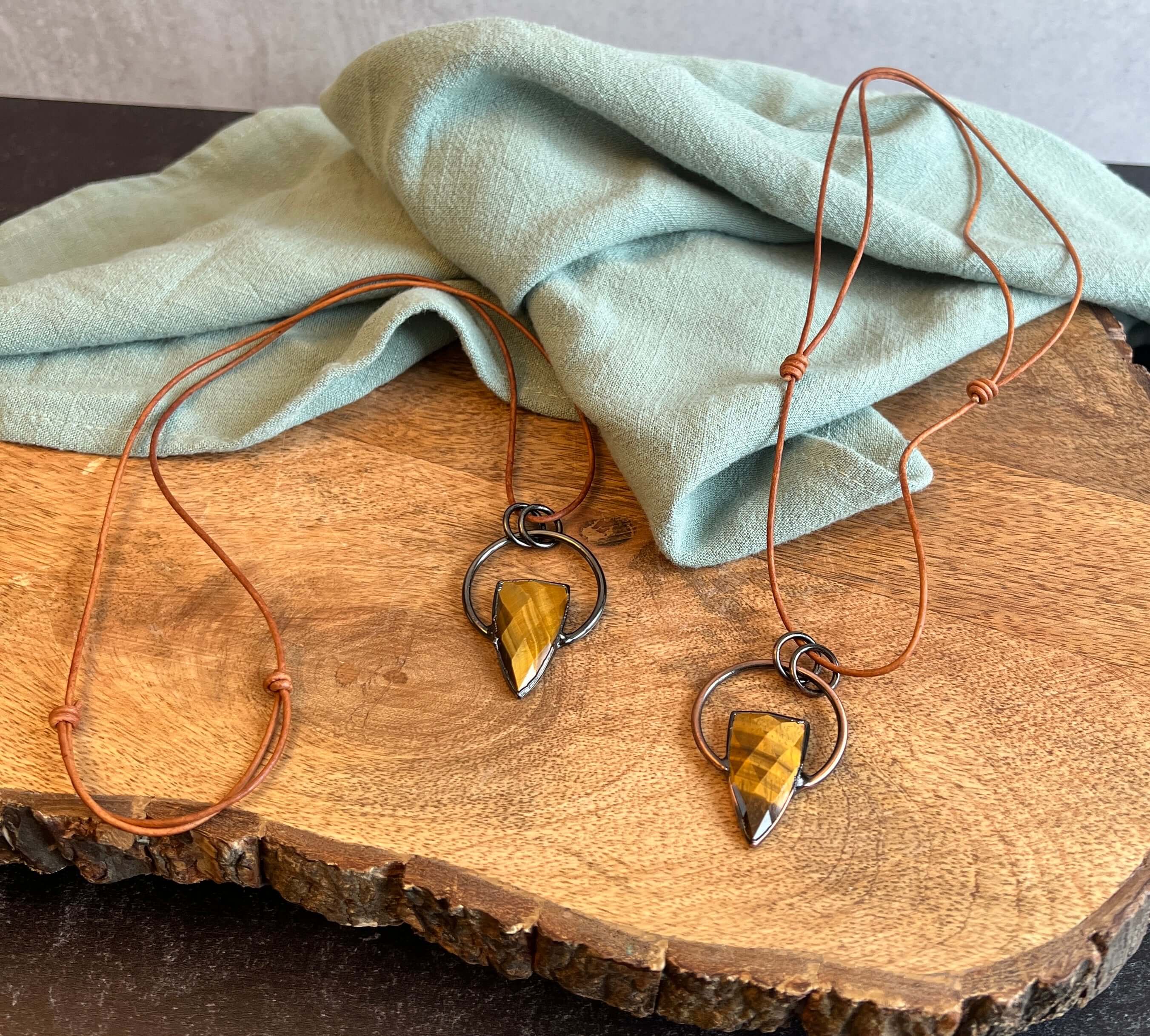 Tiger Eye Pendant Slide Knot Necklace This necklace is made with high-quality Tiger Eye gemstones which bring clarity and grounding energy to the wearer. Zodiac Signs: Leo and Capricorn. Chakras: Sacral, Solar Plexus, and Third Eye. Handmade with authenti