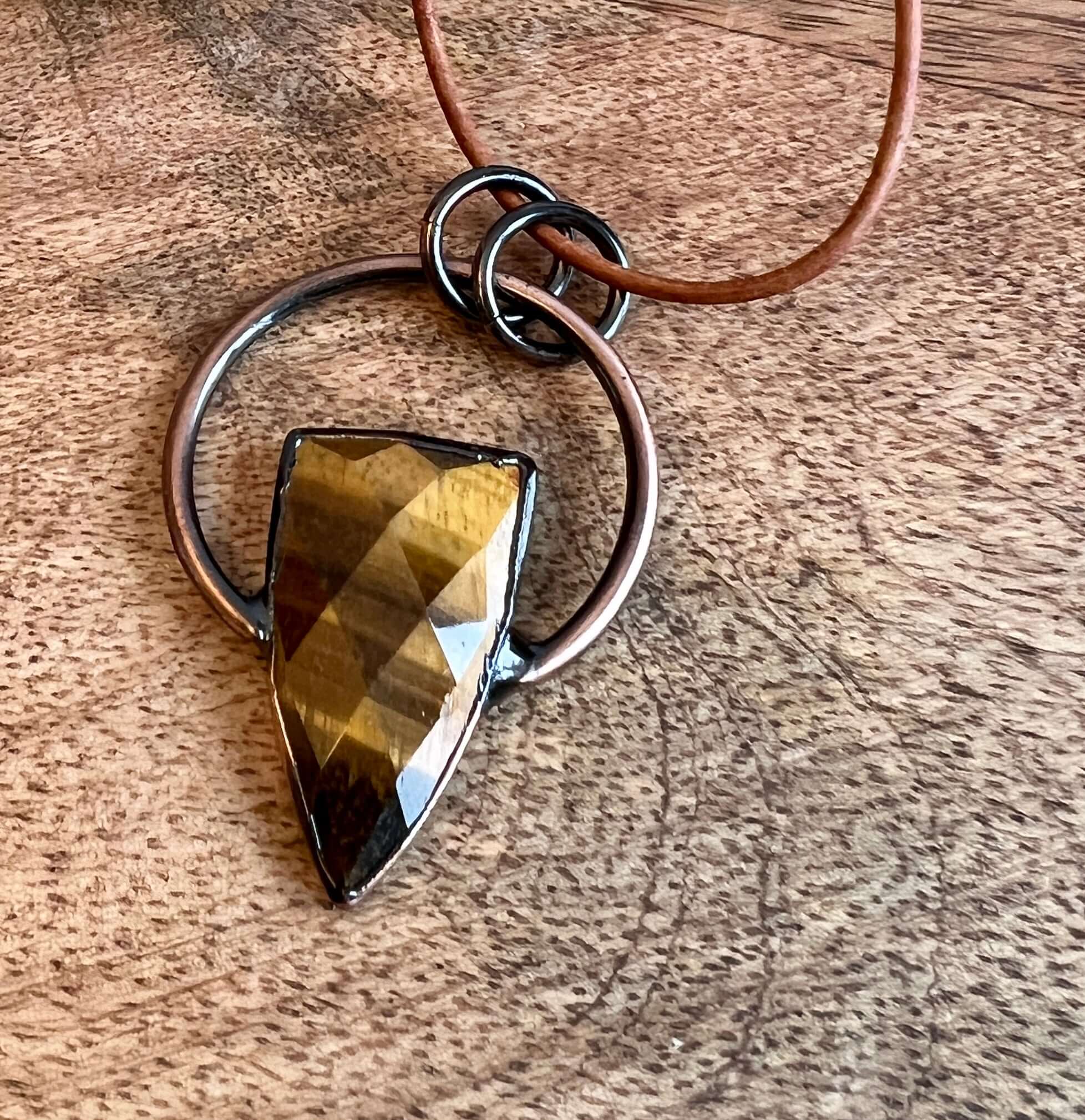 Tiger Eye Pendant Slide Knot Necklace This necklace is made with high-quality Tiger Eye gemstones which bring clarity and grounding energy to the wearer. Zodiac Signs: Leo and Capricorn. Chakras: Sacral, Solar Plexus, and Third Eye. Handmade with authenti