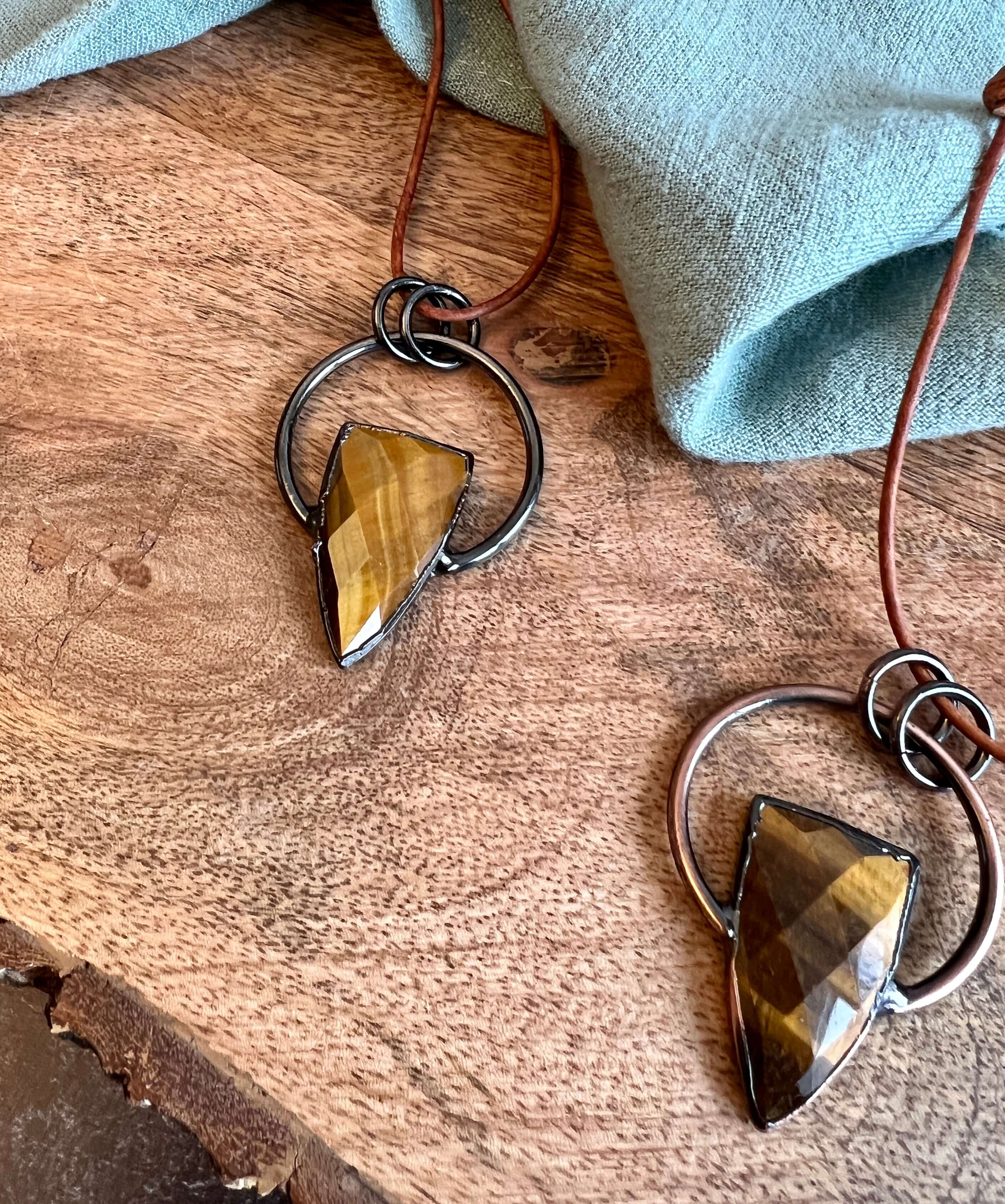 Tiger Eye Pendant Slide Knot Necklace This necklace is made with high-quality Tiger Eye gemstones which bring clarity and grounding energy to the wearer. Zodiac Signs: Leo and Capricorn. Chakras: Sacral, Solar Plexus, and Third Eye. Handmade with authenti