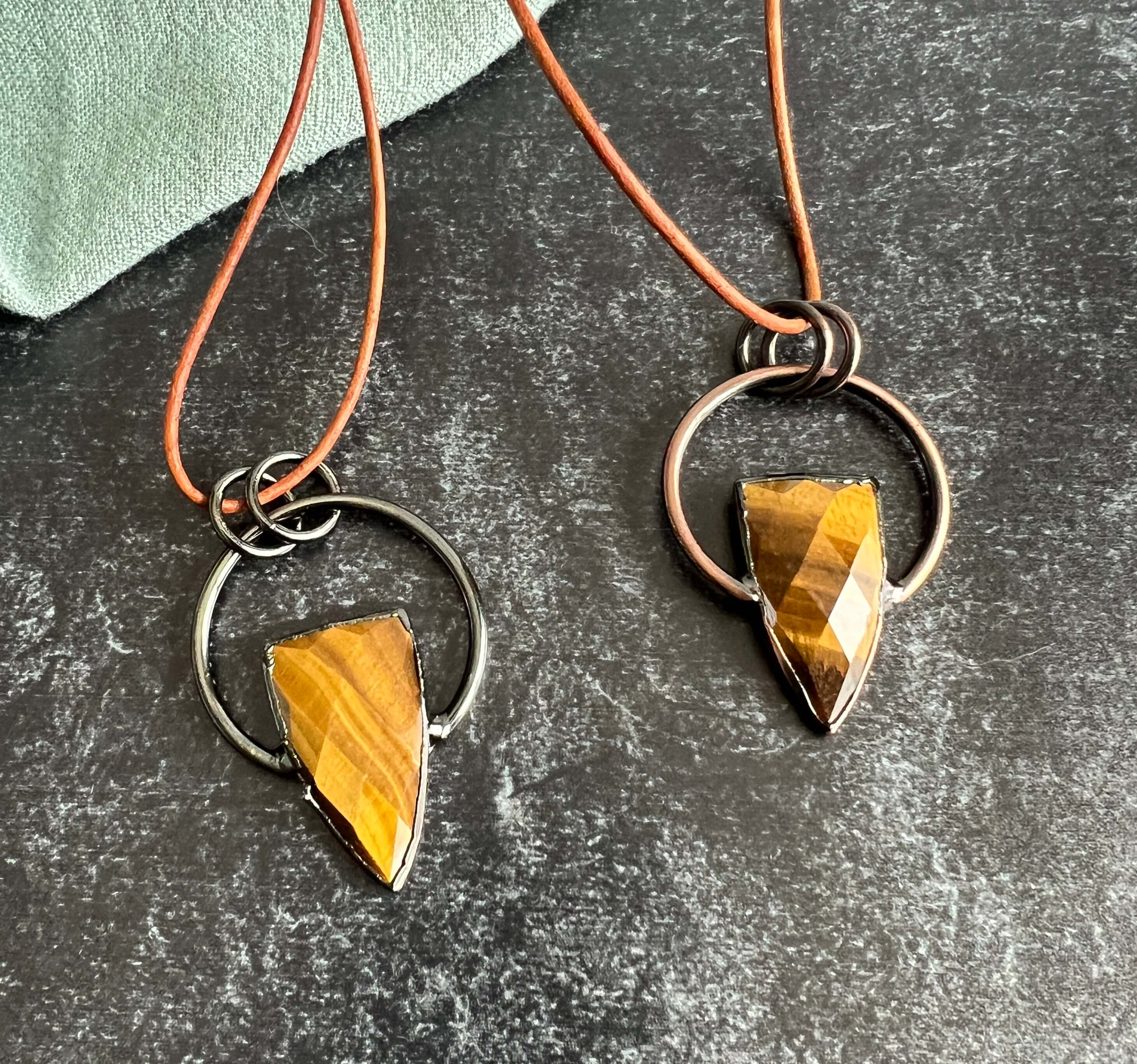 Tiger Eye Pendant Slide Knot Necklace This necklace is made with high-quality Tiger Eye gemstones which bring clarity and grounding energy to the wearer. Zodiac Signs: Leo and Capricorn. Chakras: Sacral, Solar Plexus, and Third Eye. Handmade with authenti