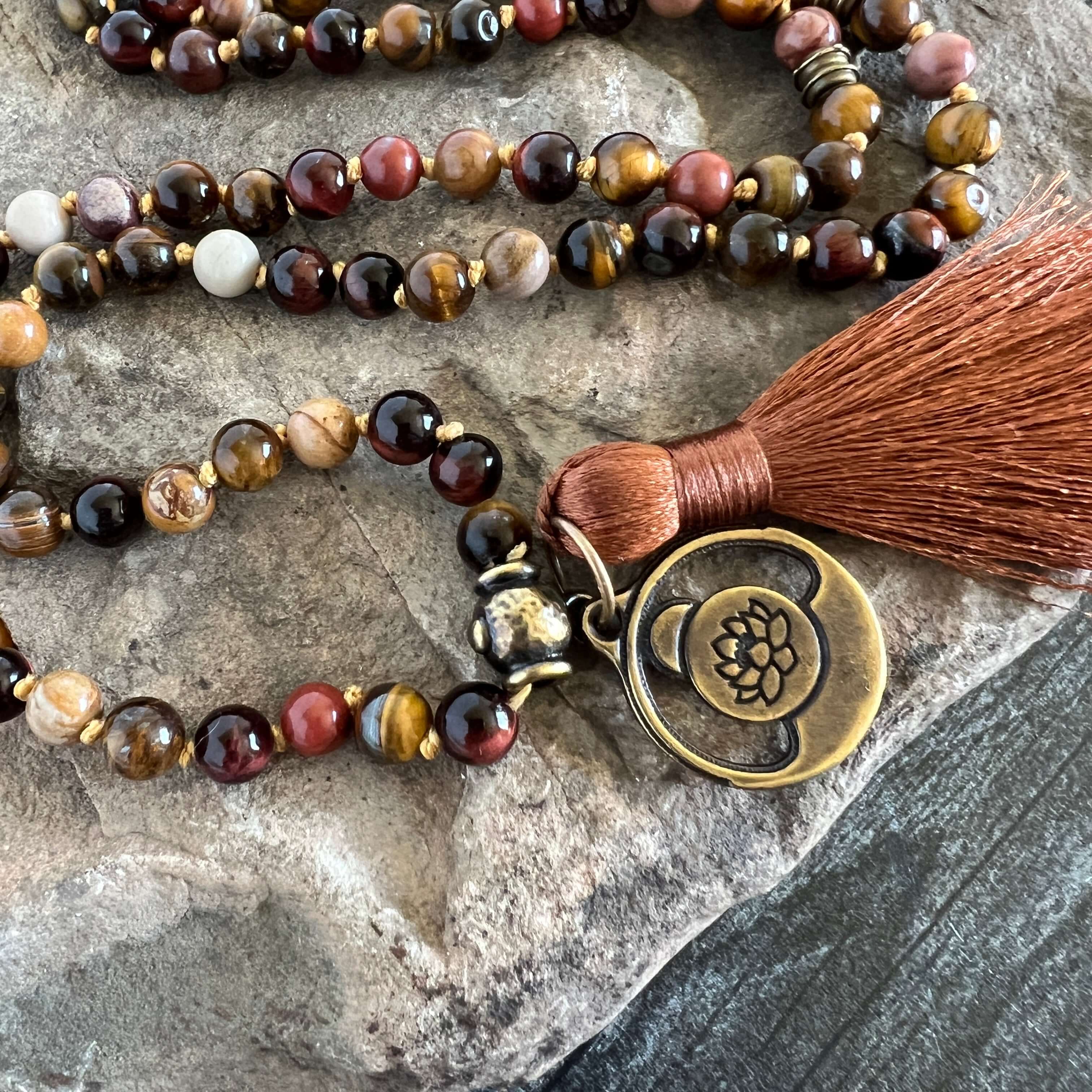 Tiger Eye Mala This mala is made with brown Tiger Eye, Red Tiger Eye, and Mookaite stones which bring a stable, grounding energy to the wearer. Due to the uniqueness of natural stone, your mala may look slightly different than the one pictured. Making you