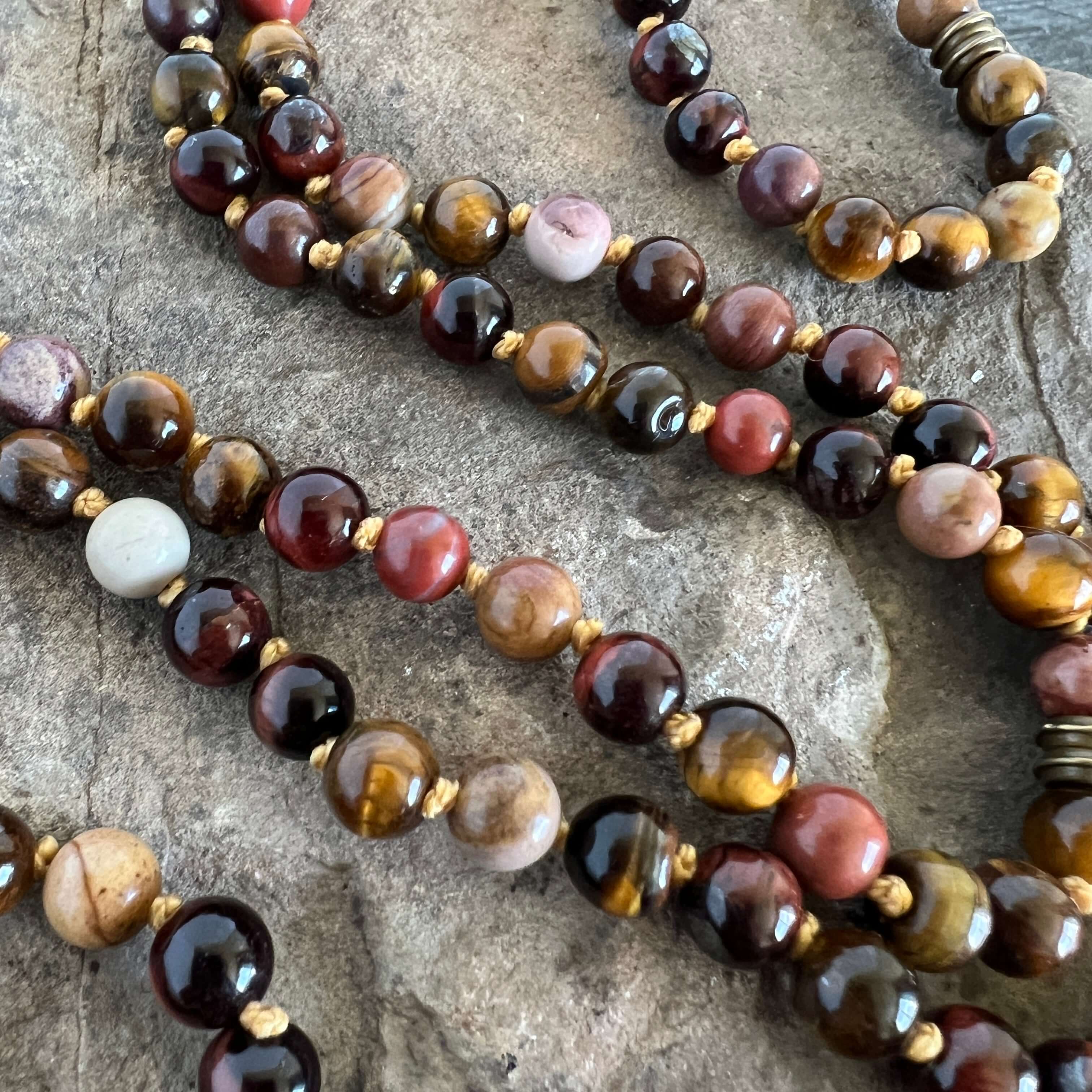 Tiger Eye Mala This mala is made with brown Tiger Eye, Red Tiger Eye, and Mookaite stones which bring a stable, grounding energy to the wearer. Due to the uniqueness of natural stone, your mala may look slightly different than the one pictured. Making you