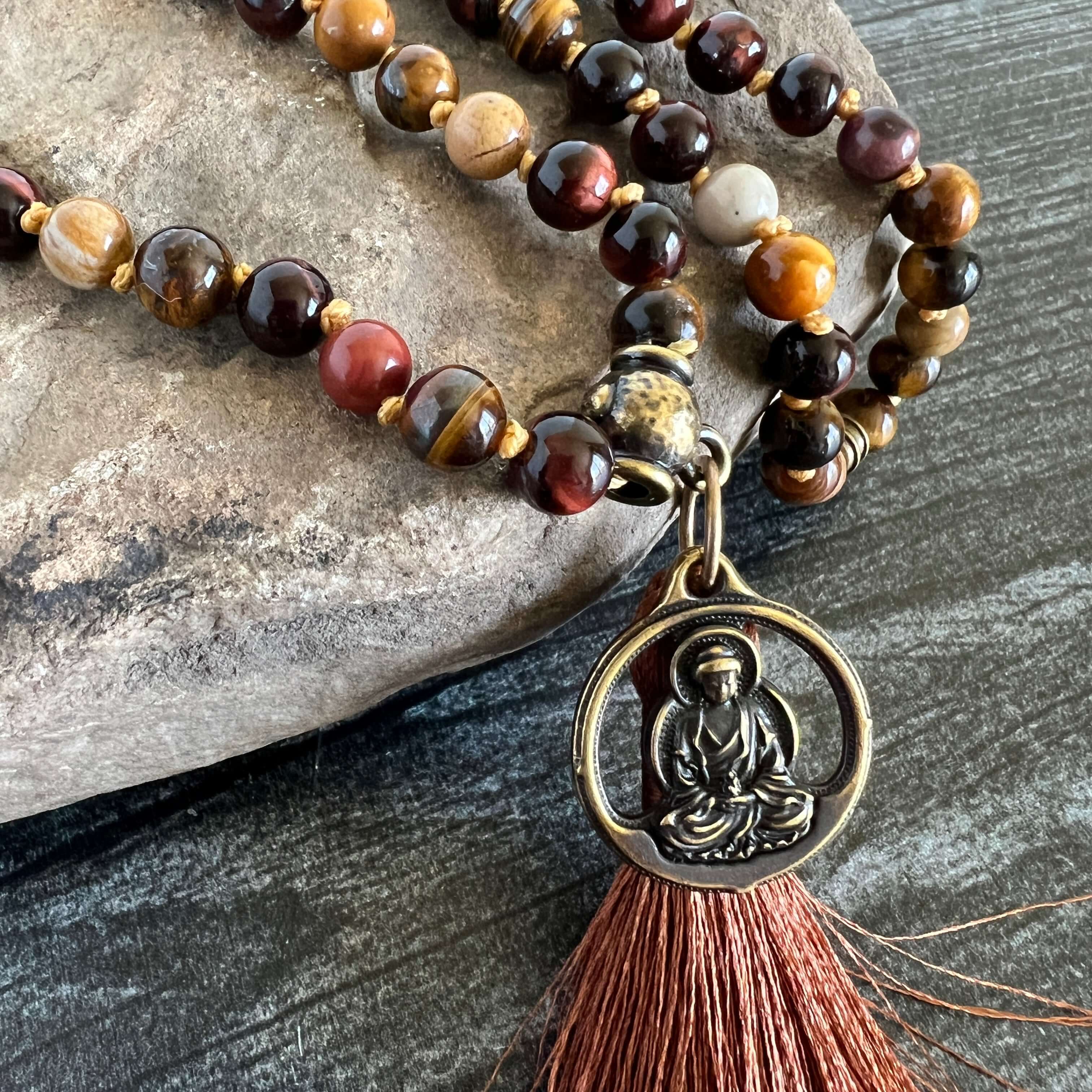 Tiger Eye Mala This mala is made with brown Tiger Eye, Red Tiger Eye, and Mookaite stones which bring a stable, grounding energy to the wearer. Due to the uniqueness of natural stone, your mala may look slightly different than the one pictured. Making you