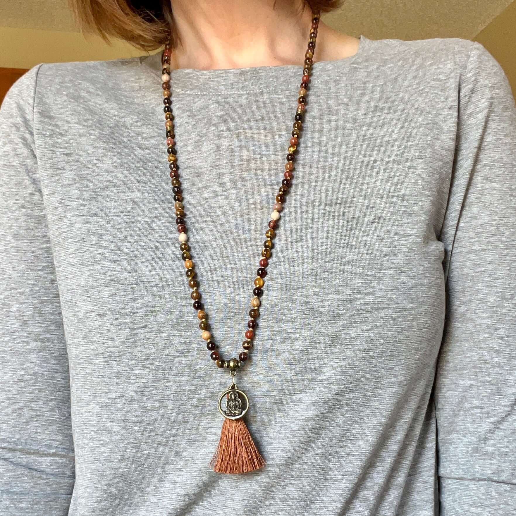 Tiger Eye Mala This mala is made with brown Tiger Eye, Red Tiger Eye, and Mookaite stones which bring a stable, grounding energy to the wearer. Due to the uniqueness of natural stone, your mala may look slightly different than the one pictured. Making you