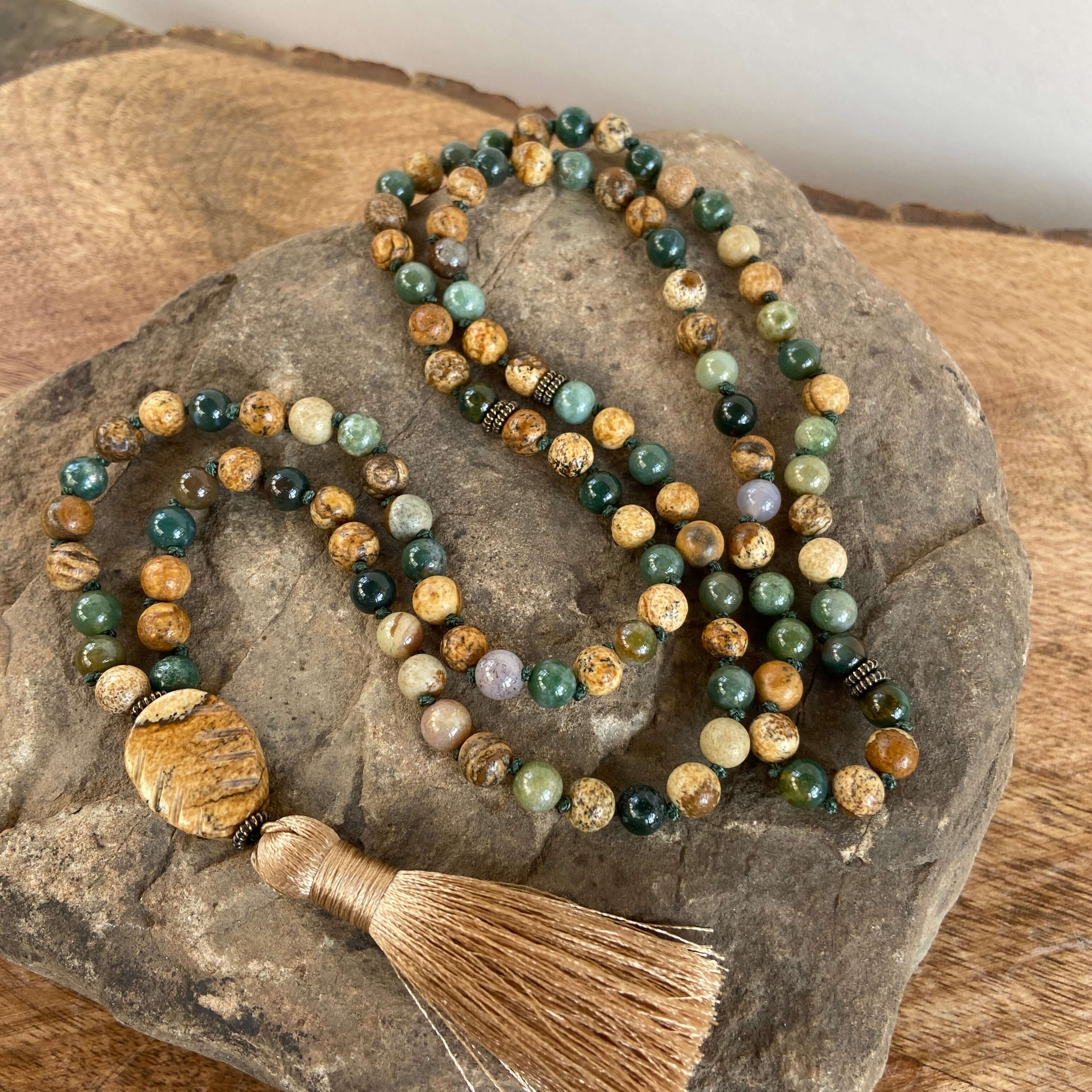 Tree Mala While creating these malas, I kept imaging the look of trees along the north shore of Lake Superior. It is made with 6mm sized Moss Agate and Picture Jasper stones, along with a Picture Jasper guru bead carved to look like a leaf. and brown silk