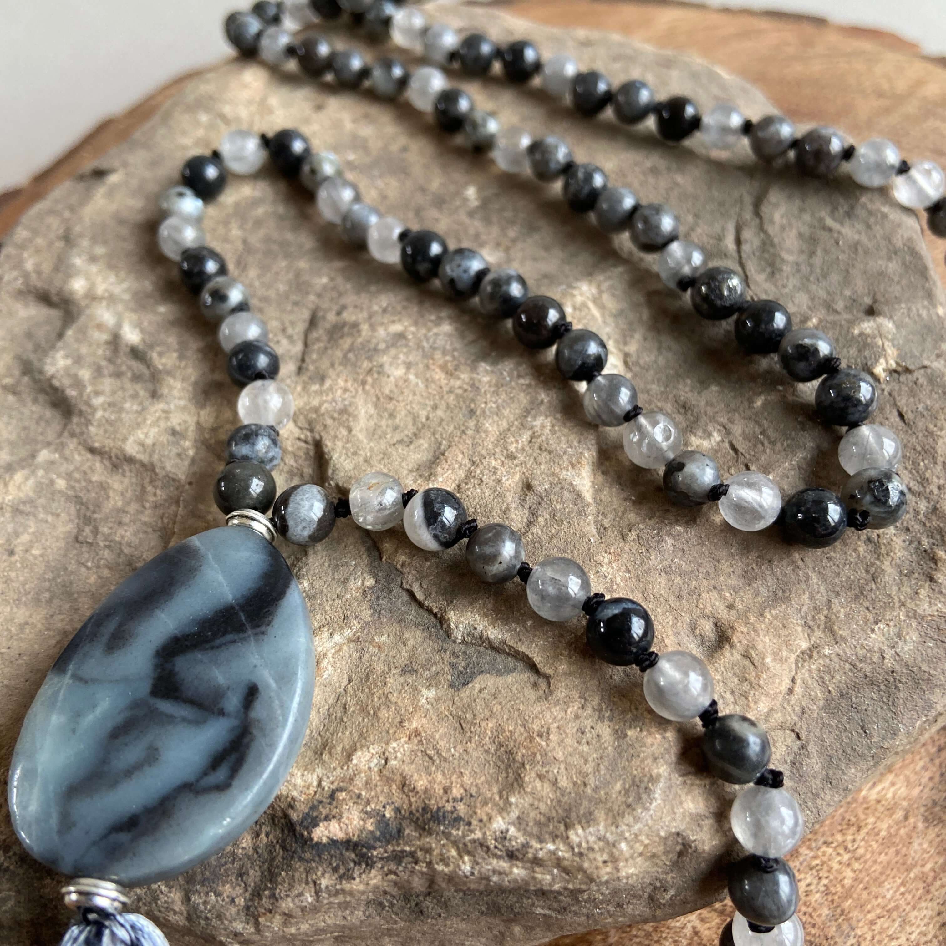 Transformation Mala This mala is made with 6mm Blue Labradorite, Cloud Quartz, and Amazonite beads. The guru stone is Amazonite. It is strung on black nylon thread and hand knotted between each stone. Blue Labradorite is a stone of transformation and chan