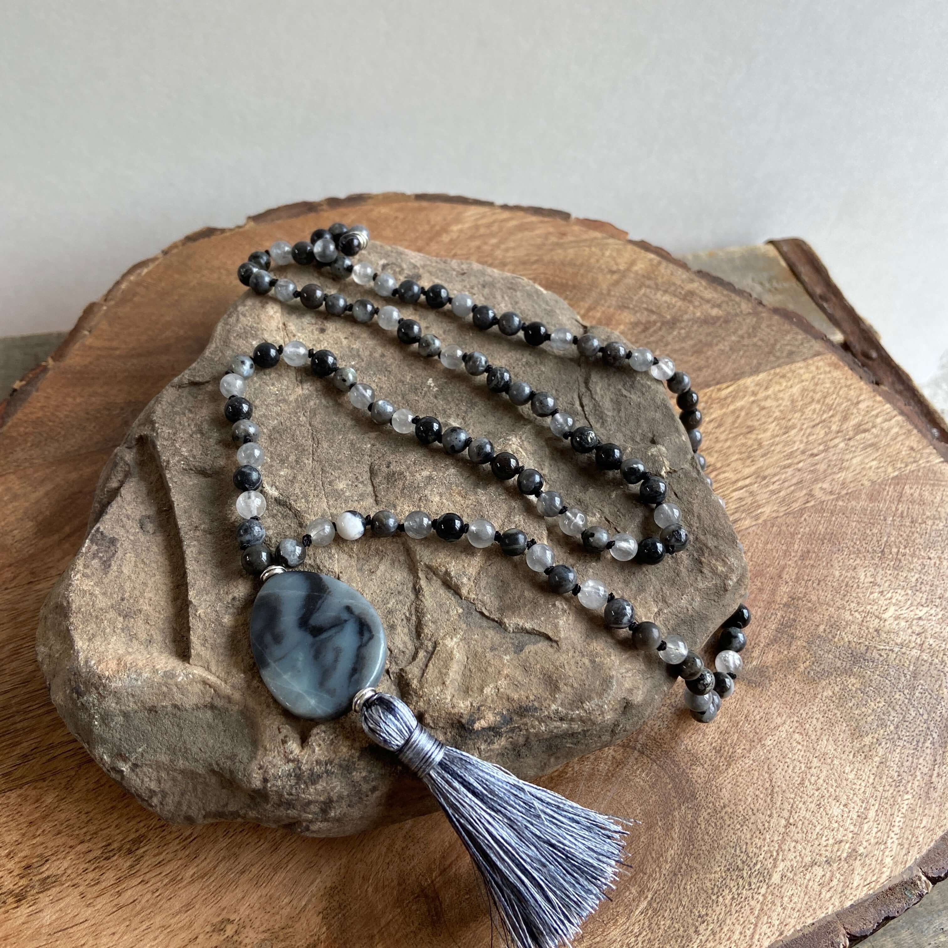 Transformation Mala This mala is made with 6mm Blue Labradorite, Cloud Quartz, and Amazonite beads. The guru stone is Amazonite. It is strung on black nylon thread and hand knotted between each stone. Blue Labradorite is a stone of transformation and chan