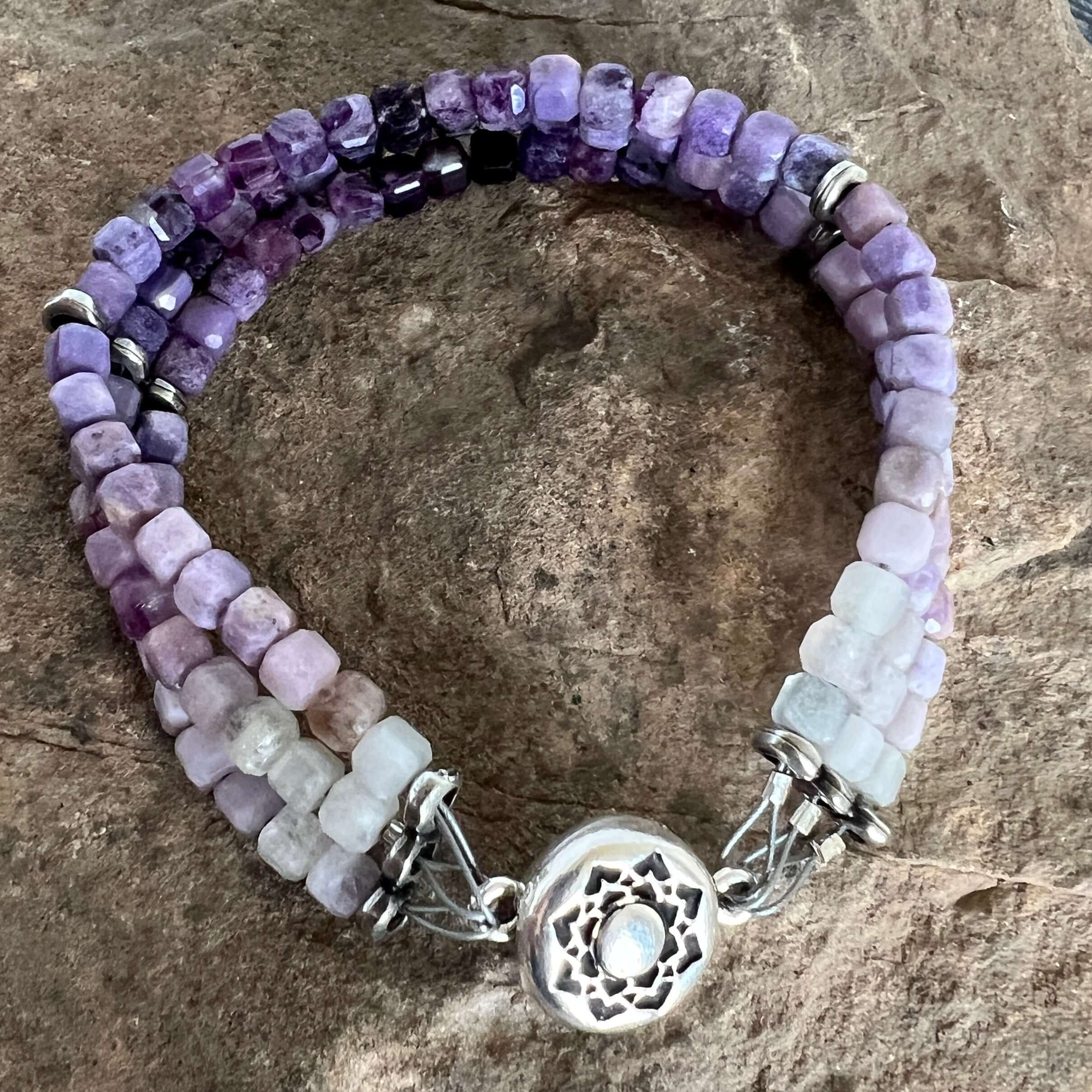 Silky Fluorite Stacked Bracelet Silky Fluorite is a rare form of Fluorite with a silky opaque luster. The luster appearance is from quartz inclusions. These quartz inclusions influence the passing of light through the mineral thus creating a silky, fibrou