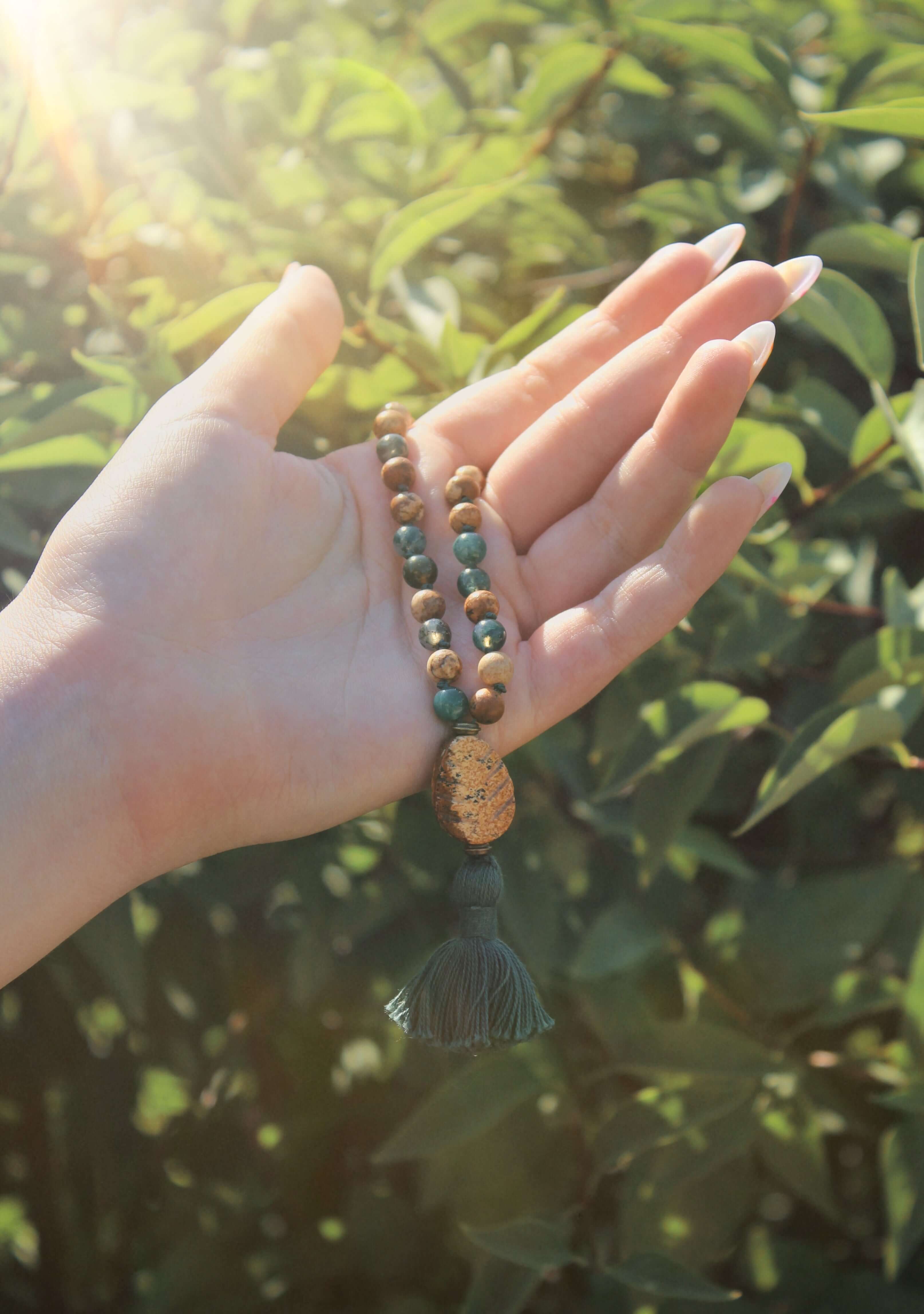 Pine Tree Quarter Mala This quarter mala is made with high-quality Picture Jasper and Moss Agate gemstones which bring confidence and abundance to the wearer. Zodiac Signs: Leo, Capricorn, & Virgo. Chakras: Root, Third Eye, & Heart. Handmade with authenti