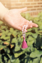 Load image into Gallery viewer, Rose Quartz Wrist Mala These quarter malas are made with high-quality Rose Quartz, Lepidolite, and Moonstone beads which bring love, release, and inspiration to the wearer. Zodiac Signs: Libra and Taurus. Chakras: Third Eye, Crown, Heart and Sacral. Handm
