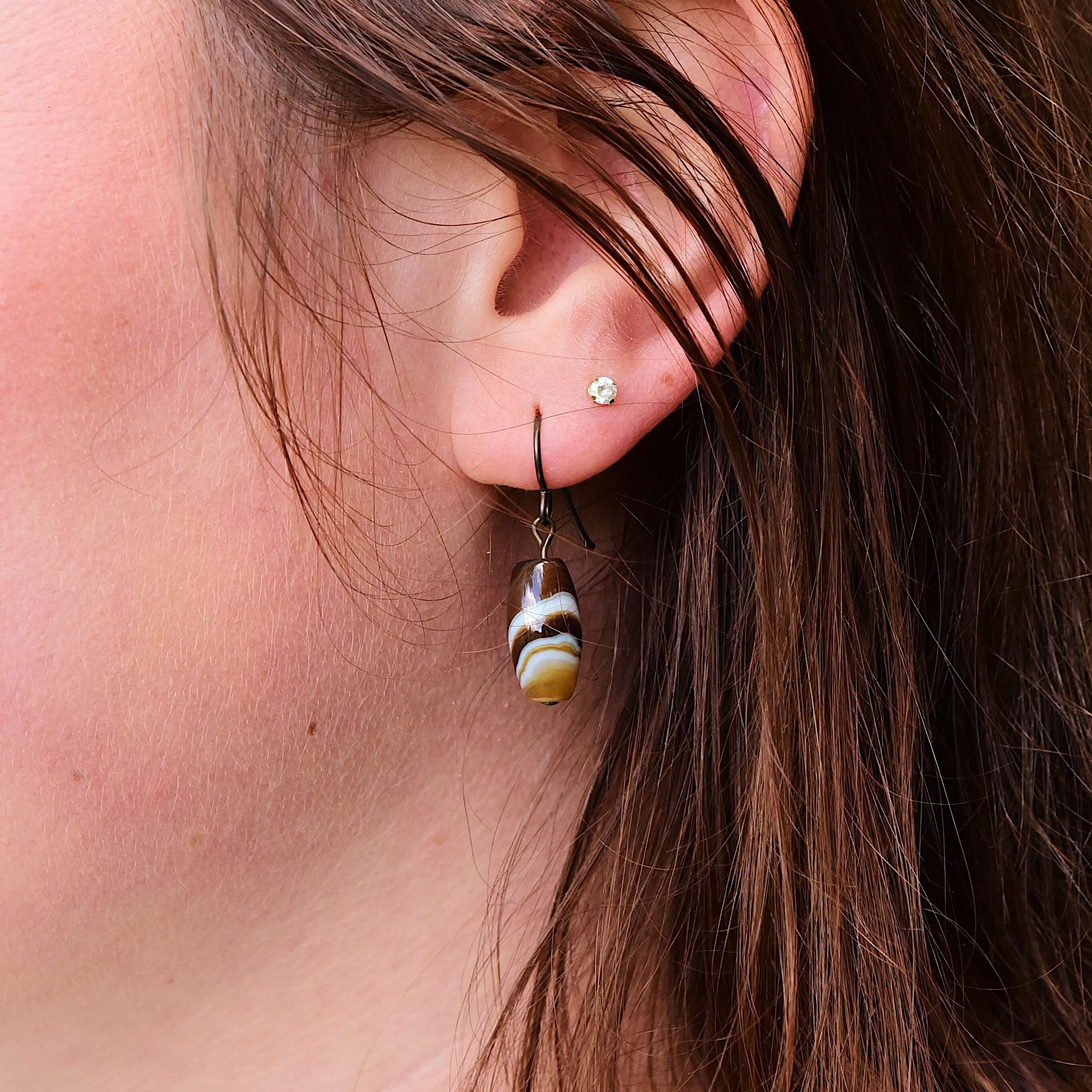 Tibetan Agate Earrings These earrings are made with authentic Tibetan Agate gemstones, which is believed to bestow its wearer with a sense of balance and protection, shielding you from negative energies while enhancing your inner strength and resilience.