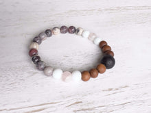 Load image into Gallery viewer, Lava Stone Focal Bracelet with Sandalwood This bracelet is made with a Lava focal bead, Sandalwood, White Jade, pink Morganite, and Porcelain Jasper. Together these stones work together to bring the wearer a sense of tranquility, love, and abundance.
