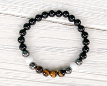 Load image into Gallery viewer, Triple Protection Obsidian, Tiger Eye, and Hematite Bracelet This bracelet is made with Black Obsidian, Tiger Eye, and Hematite. These stones together brings the wearer protection against negative energy of all kinds- inner, spiritual, and environmental.
