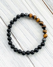Load image into Gallery viewer, Triple Protection Obsidian, Tiger Eye, and Hematite Bracelet This bracelet is made with Black Obsidian, Tiger Eye, and Hematite. These stones together brings the wearer protection against negative energy of all kinds- inner, spiritual, and environmental.
