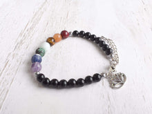 Load image into Gallery viewer, Obsidian Chakra Bracelet This bracelet is made with black obsidian, and chakra stones with a lotus charm. These stones together help the wearer balance the energy of their chakras. Stones include Jasper, Aventurine, Moonstone, Turquoise, Sodalite, Amethys
