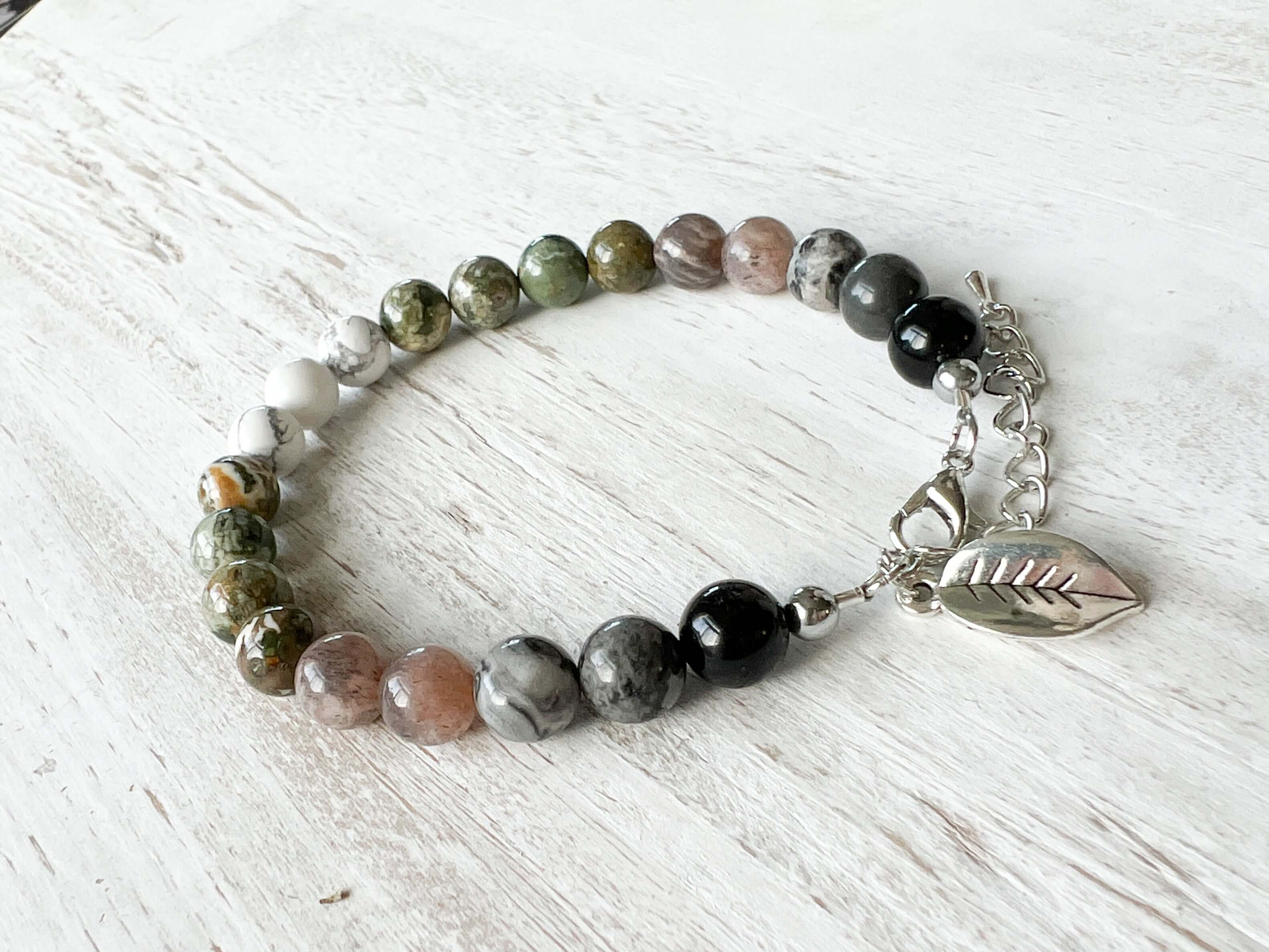 Earth Element Bracelet This bracelet is made with Black Obsidian, Gray Map Jasper, Gray Moonstone, Rhyolite, and Howlite to represent the Earth element. These stones offer a sense of tranquility, enhanced third eye visualization, and self-worth.