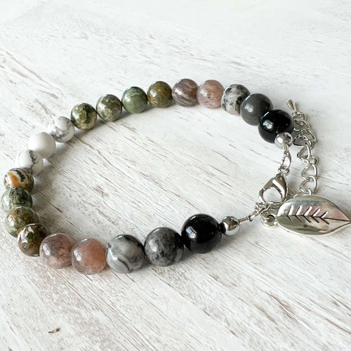 Earth Element Bracelet This bracelet is made with Black Obsidian, Gray Map Jasper, Gray Moonstone, Rhyolite, and Howlite to represent the Earth element. These stones offer a sense of tranquility, enhanced third eye visualization, and self-worth.