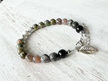 Load image into Gallery viewer, Earth Element Bracelet This bracelet is made with Black Obsidian, Gray Map Jasper, Gray Moonstone, Rhyolite, and Howlite to represent the Earth element. These stones offer a sense of tranquility, enhanced third eye visualization, and self-worth.
