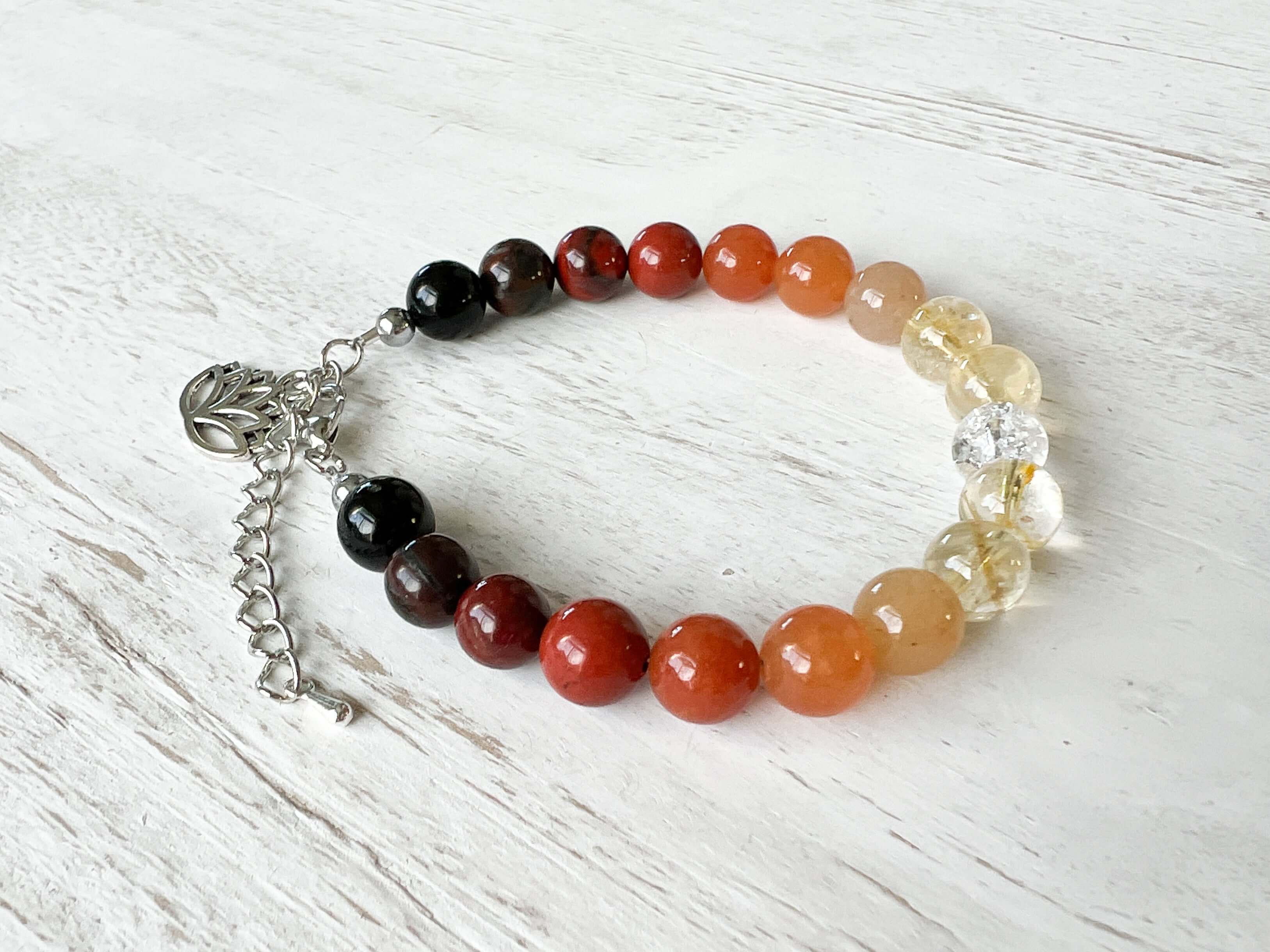 Fire Element Bracelet This bracelet is made with Black Obsidian, Red Jasper, Red Aventurine, Citrine, and Clear Quartz to represent the fire element. These stones bring the wearer a sense of self empowerment, determination, and clarity.