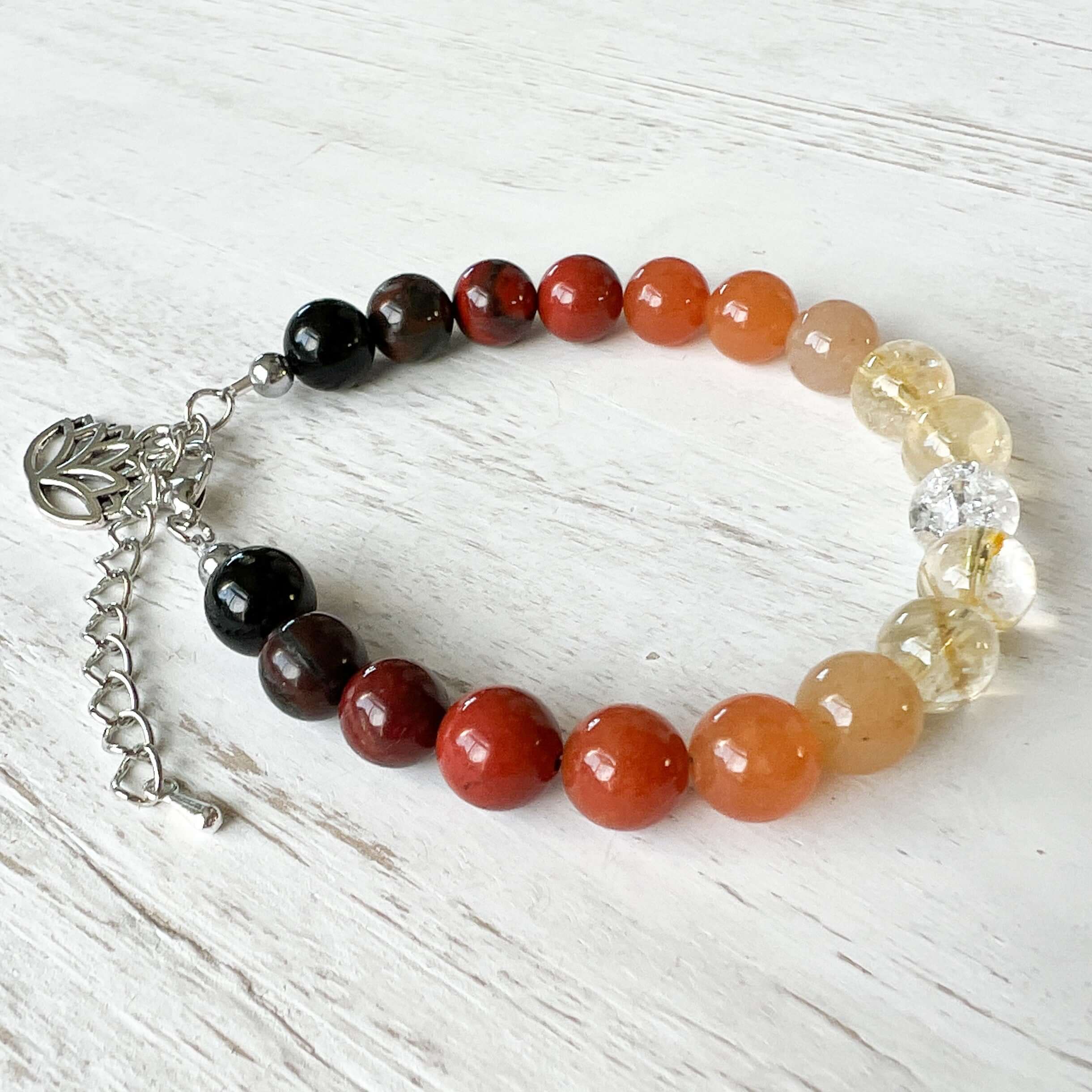 Fire Element Bracelet This bracelet is made with Black Obsidian, Red Jasper, Red Aventurine, Citrine, and Clear Quartz to represent the fire element. These stones bring the wearer a sense of self empowerment, determination, and clarity.