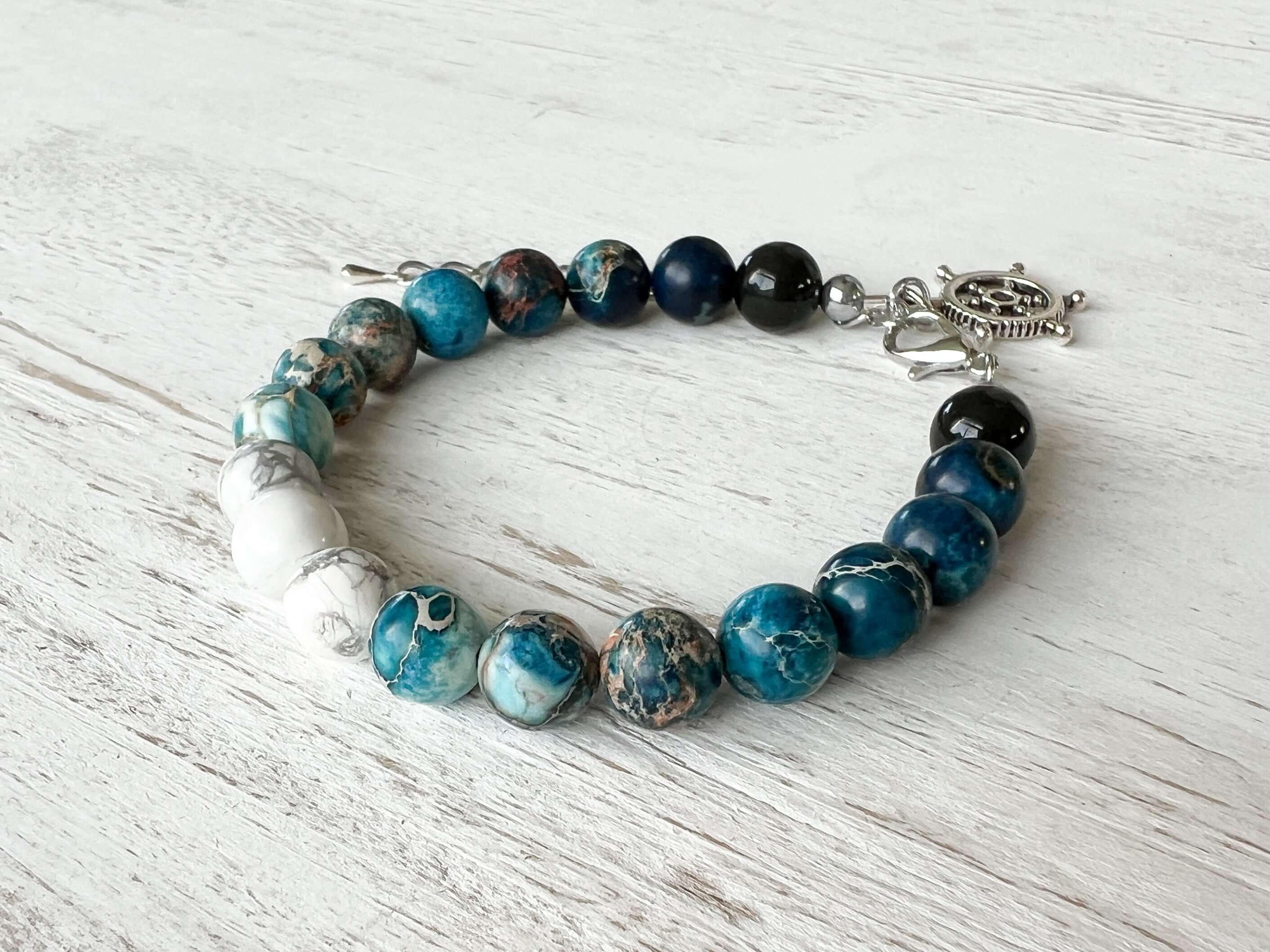 Water Element Bracelet This bracelet is made with black obsidian, dyed sea sediment jasper, and howlite. Together these stones dispel negative energy and open the wearer to emotional healing.