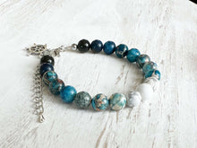 Load image into Gallery viewer, Water Element Bracelet This bracelet is made with black obsidian, dyed sea sediment jasper, and howlite. Together these stones dispel negative energy and open the wearer to emotional healing.
