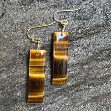 Load image into Gallery viewer, Tiger Eye Earrings These earrings are made with high-quality Tiger Eye stones which bring protection and connection to the wearer. Zodiac Signs: Leo and Capricorn Chakras: Sacral, Solar Plexus, and Third Eye. Handmade with authentic crystals and gemstones
