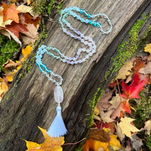 Load image into Gallery viewer, Crown Chakra Mala The Crown Chakra Mala is designed to awaken your spiritual consciousness and unlock your connection to the Divine. Handmade with multiple forms of Quartz, along with Aquamarine, and Green Fluorite, the Crown Chakra Mala provides healing
