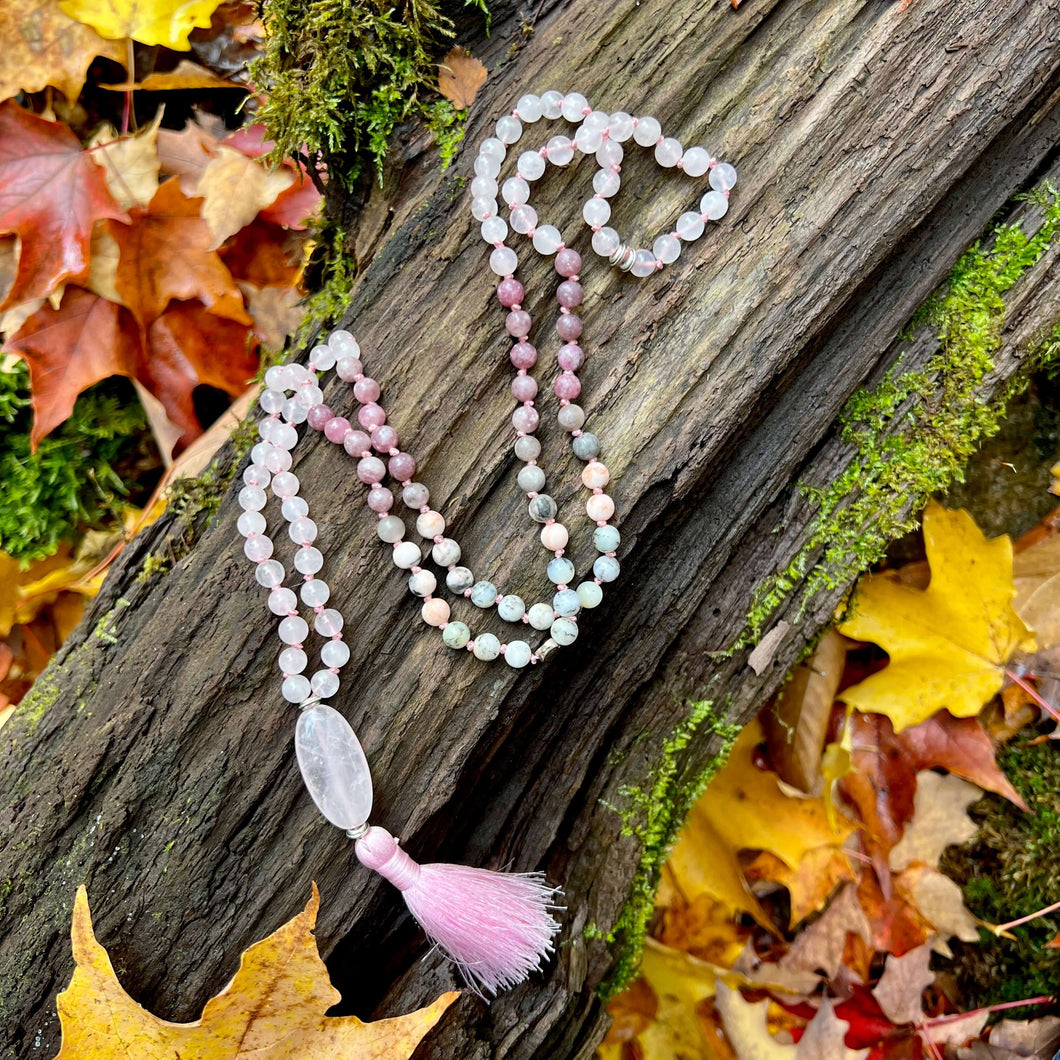 Loving Growth Mala Introducing our exquisite Loving Growth Mala Necklace crafted with high-quality Rose Quartz, Lepidolite, Pink Zebra Jasper, and Dendritic Opal. This beautifully designed mala is not just a piece of jewelry; it's a spiritual companion th